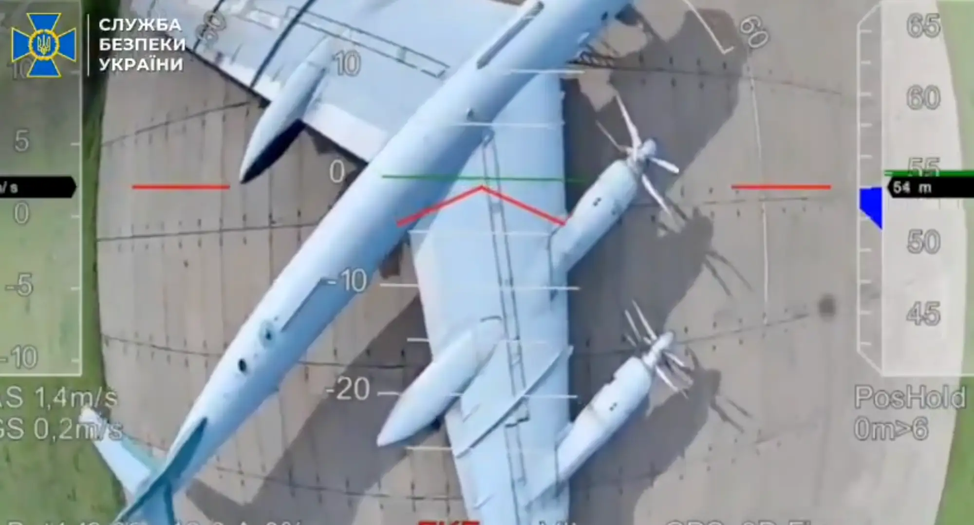 Aerial footage of a large grey aircraft on tarmac