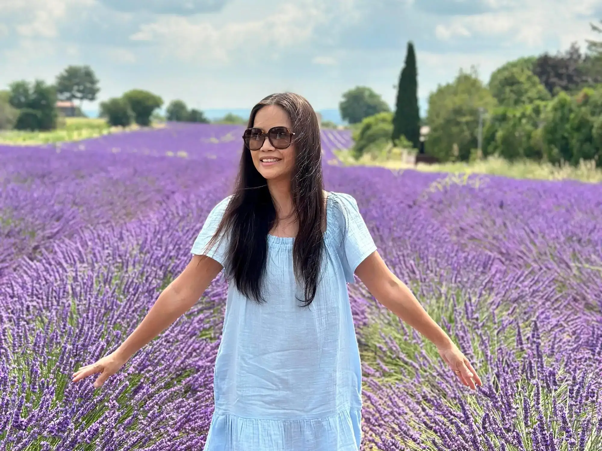 A woman in a field of purple flowers.