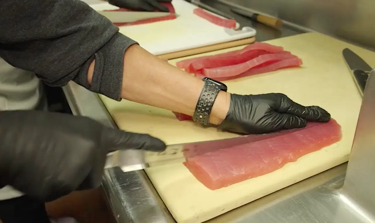 Someone slicing ahi tuna flown in from Hawaii for Governors Ball.