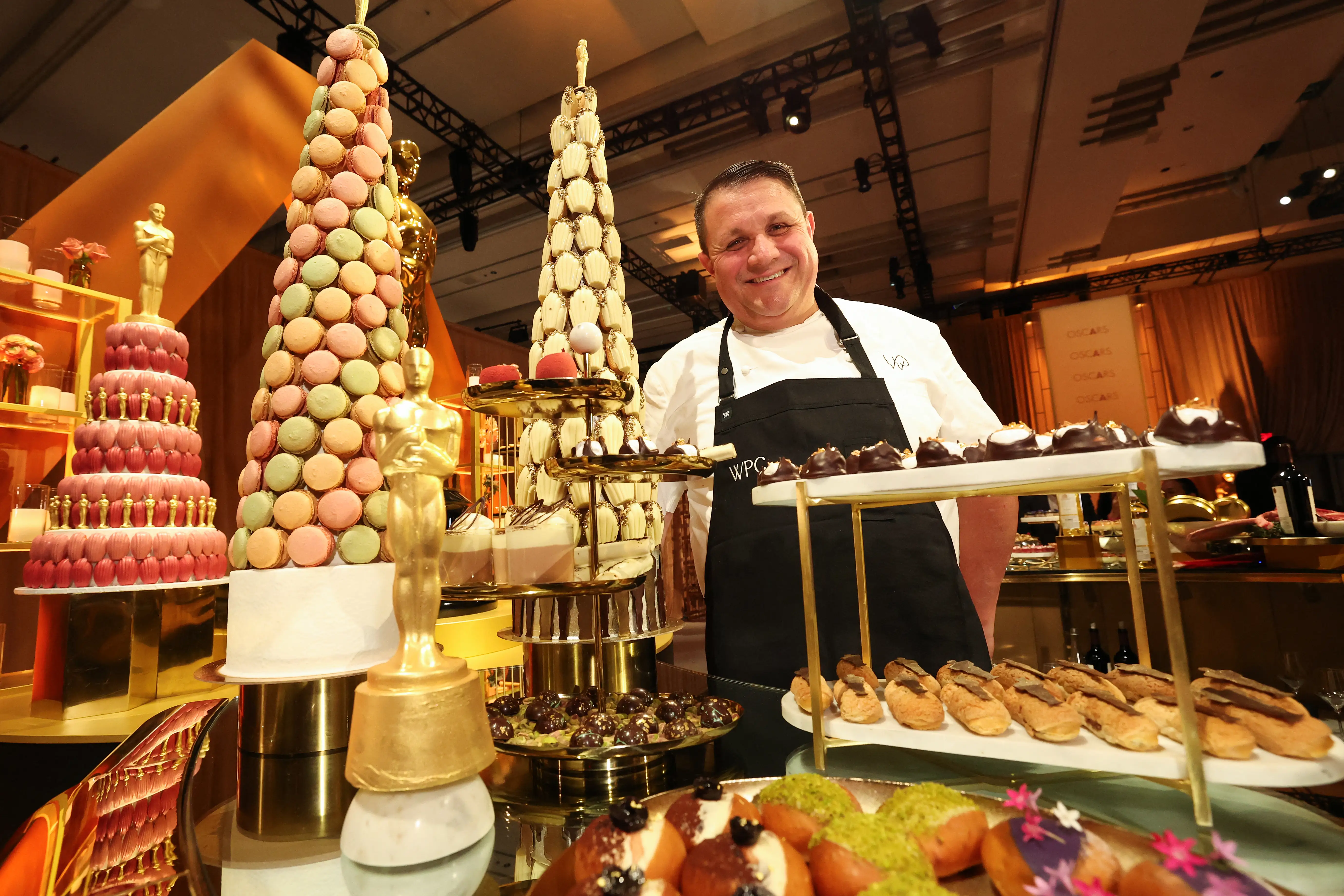 A chef poses next to a chocolate 'piece montee' at the 98th Oscars Governors Ball preview.