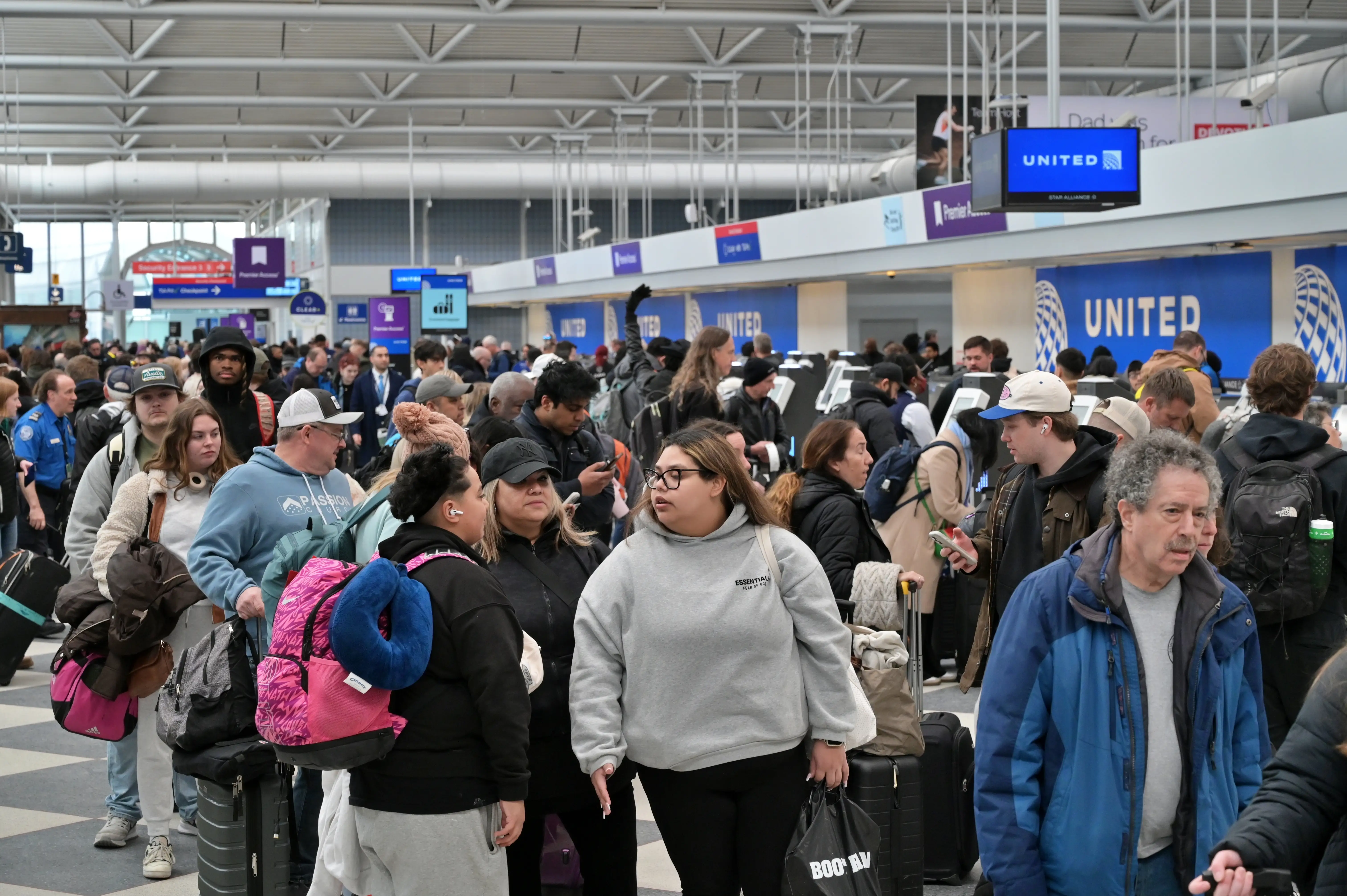 A general view shows hundreds of travelers navigating dense queues and crowded terminal walkways at O'Hare International Airport, in Chicago, Illinois, United States, on March 16, 2026.