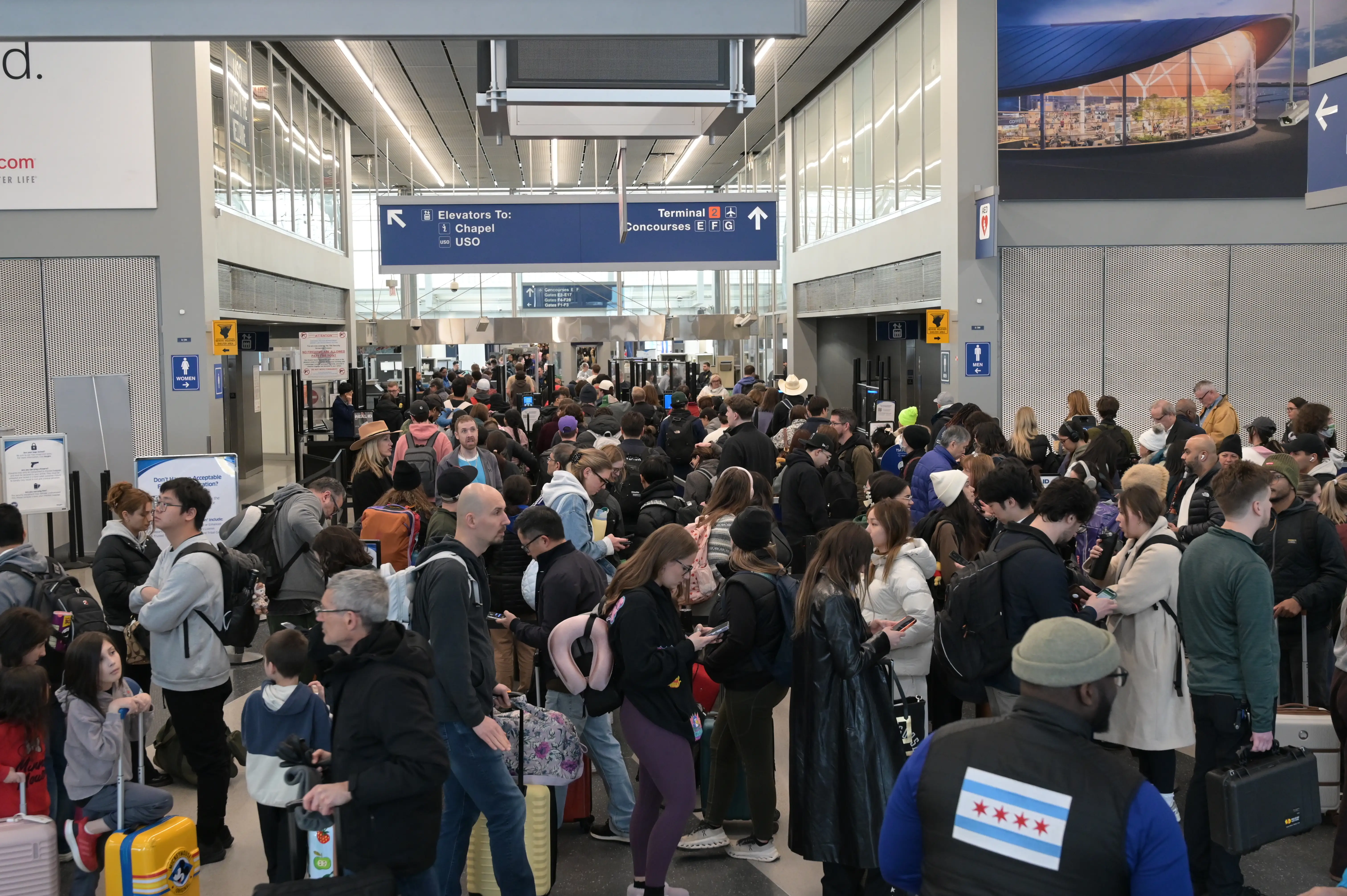 A general view shows hundreds of travelers navigating dense queues and crowded terminal walkways at O'Hare International Airport, in Chicago, Illinois, United States, on March 16, 2026.