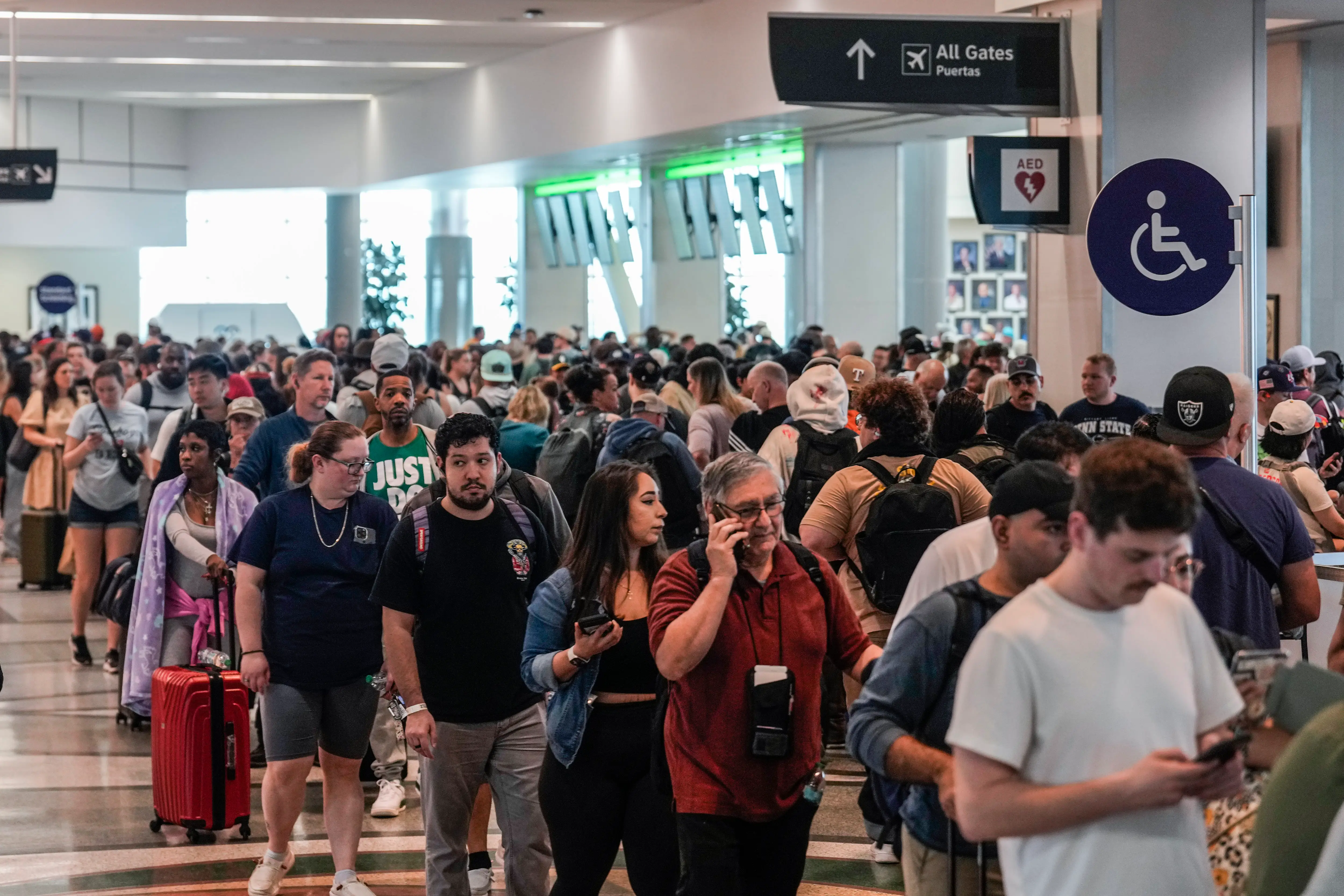 Airline passengers wait in long lines to get through the TSA security screening at William P. Hobby Airport in Houston, Sunday, March 8, 2026.