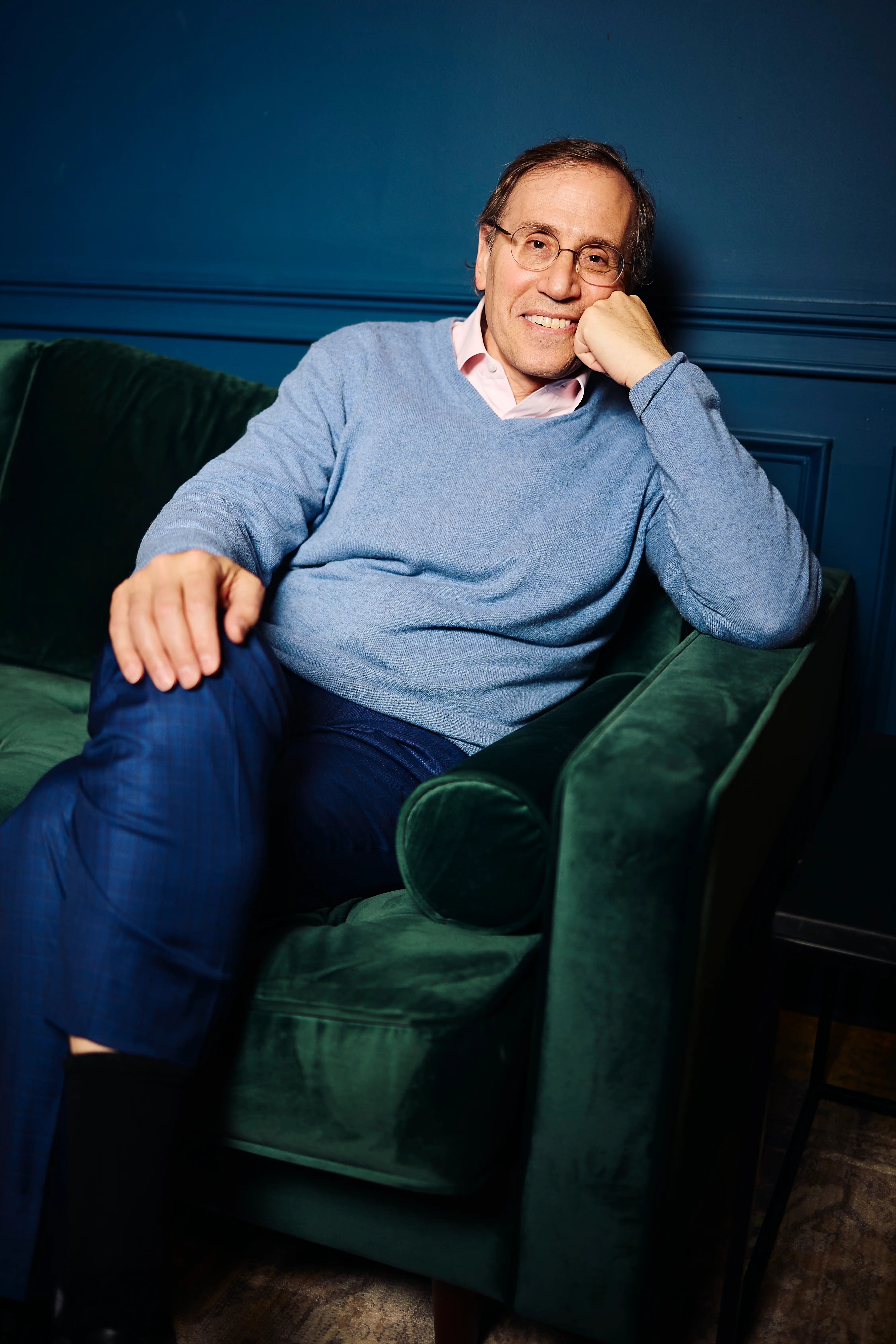 Roger Shedlin, CEO of WIN, on a couch in a shared space in his office.