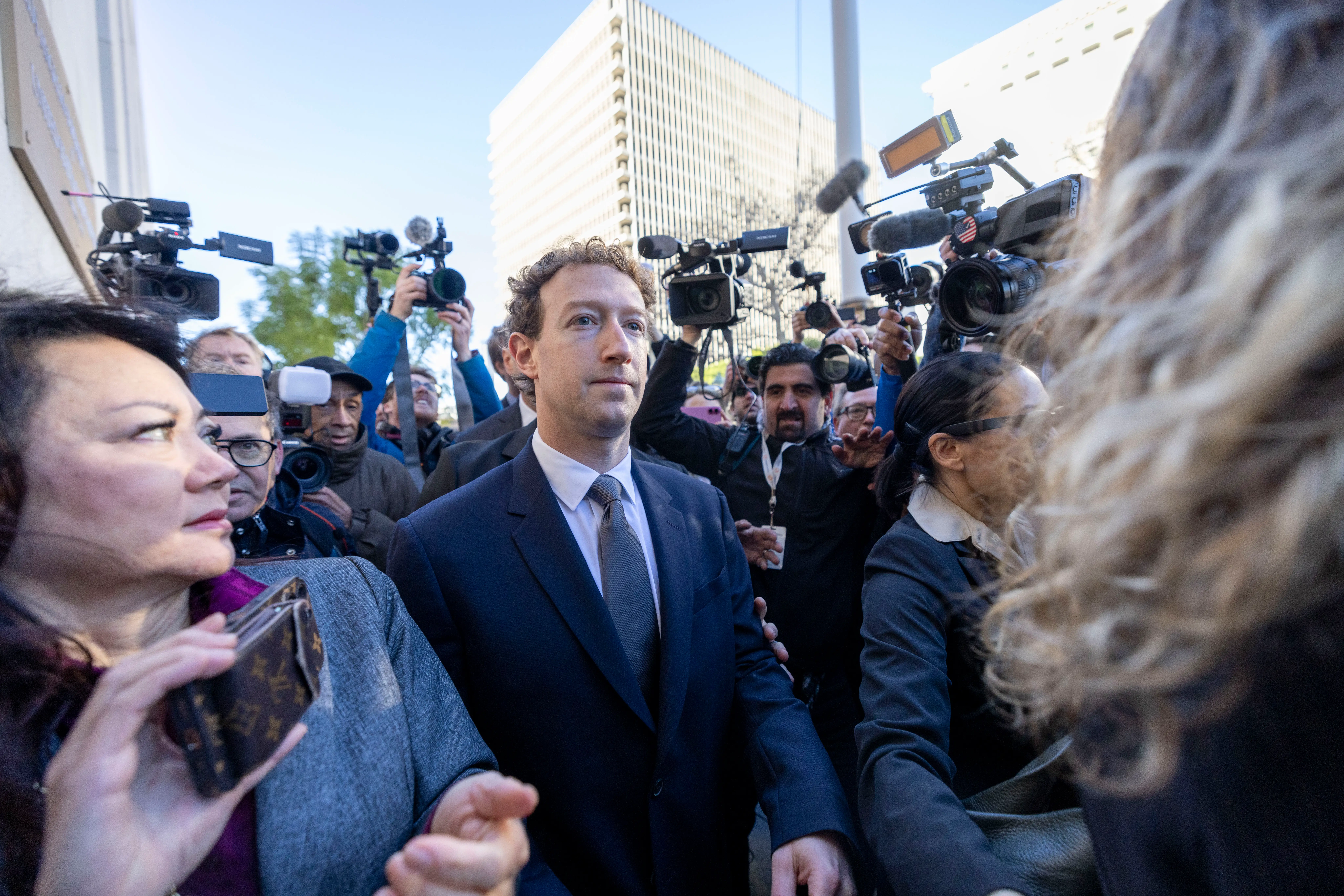 Zuckerberg surrounded by media.