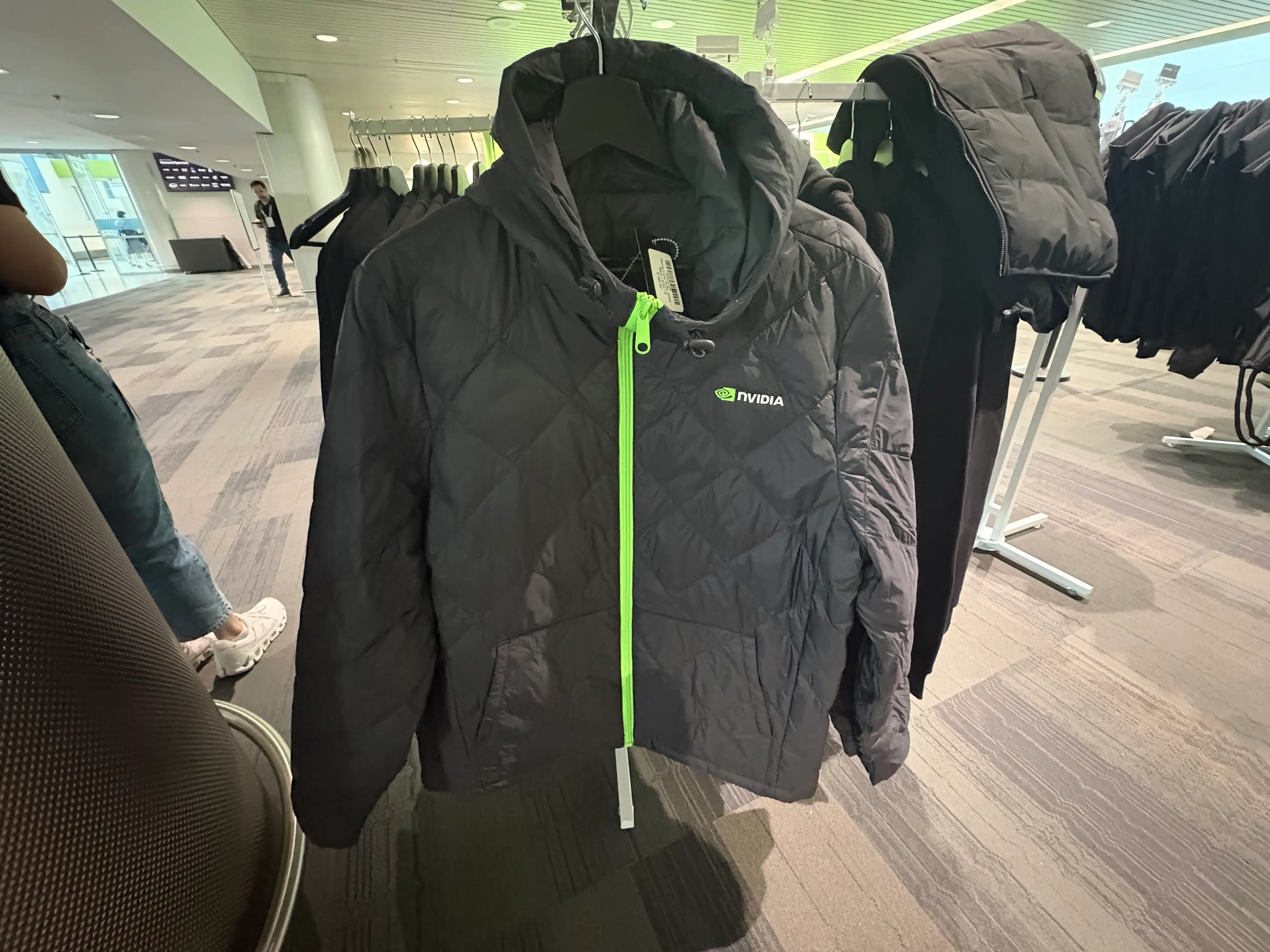 Nvidia puffer jacket with a green zipper.