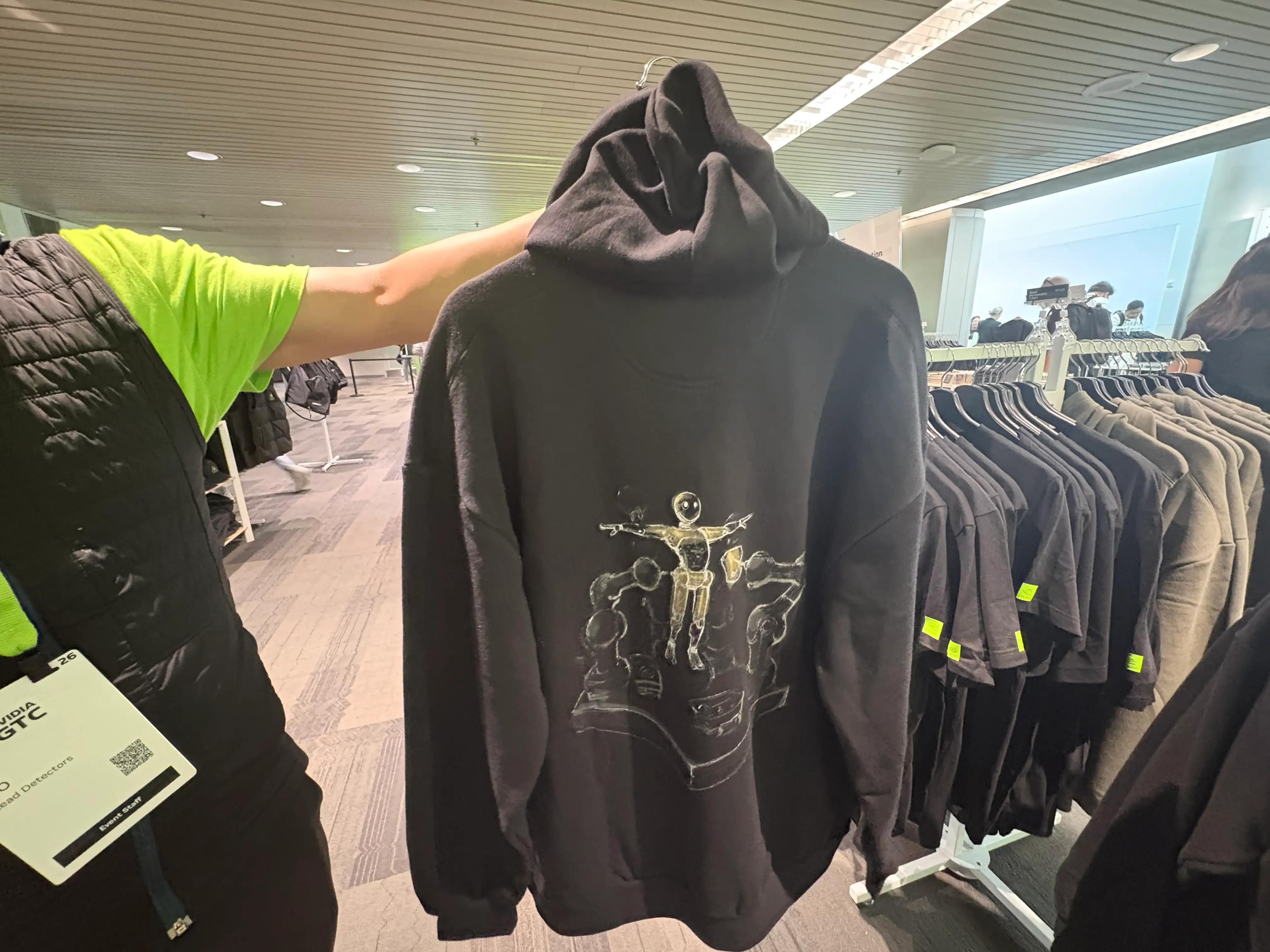 A salesperson holding up an Nvidia hoodie.