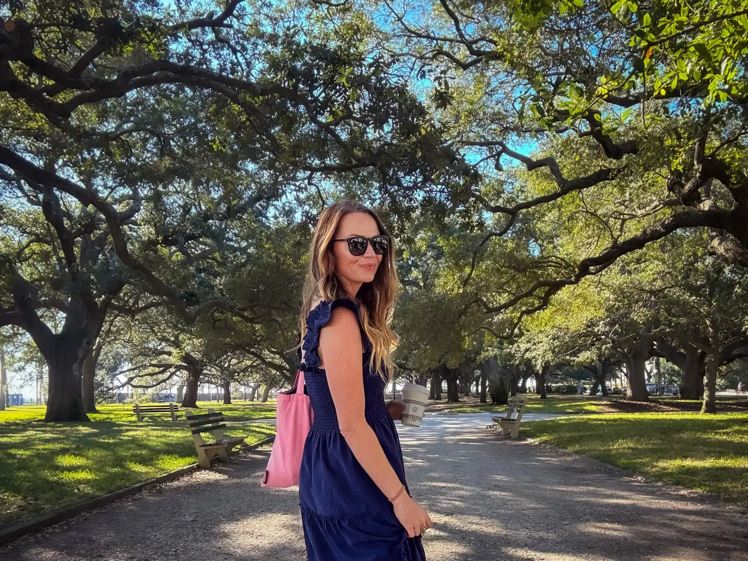 Emily walks through a park in Charleston.