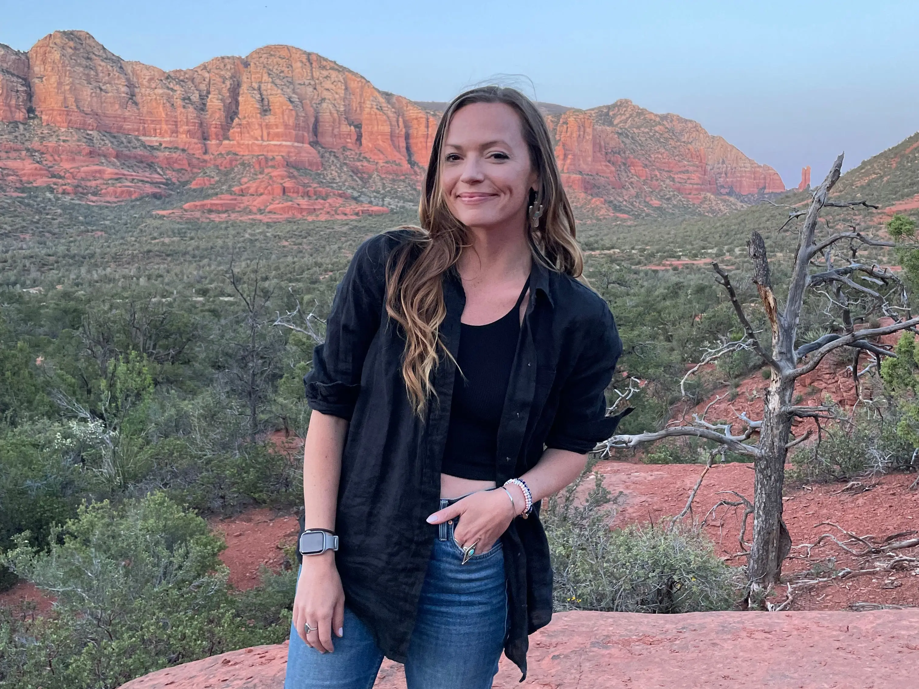 Emily stands on red rocks while on a hike in Sedona, Arizona.
