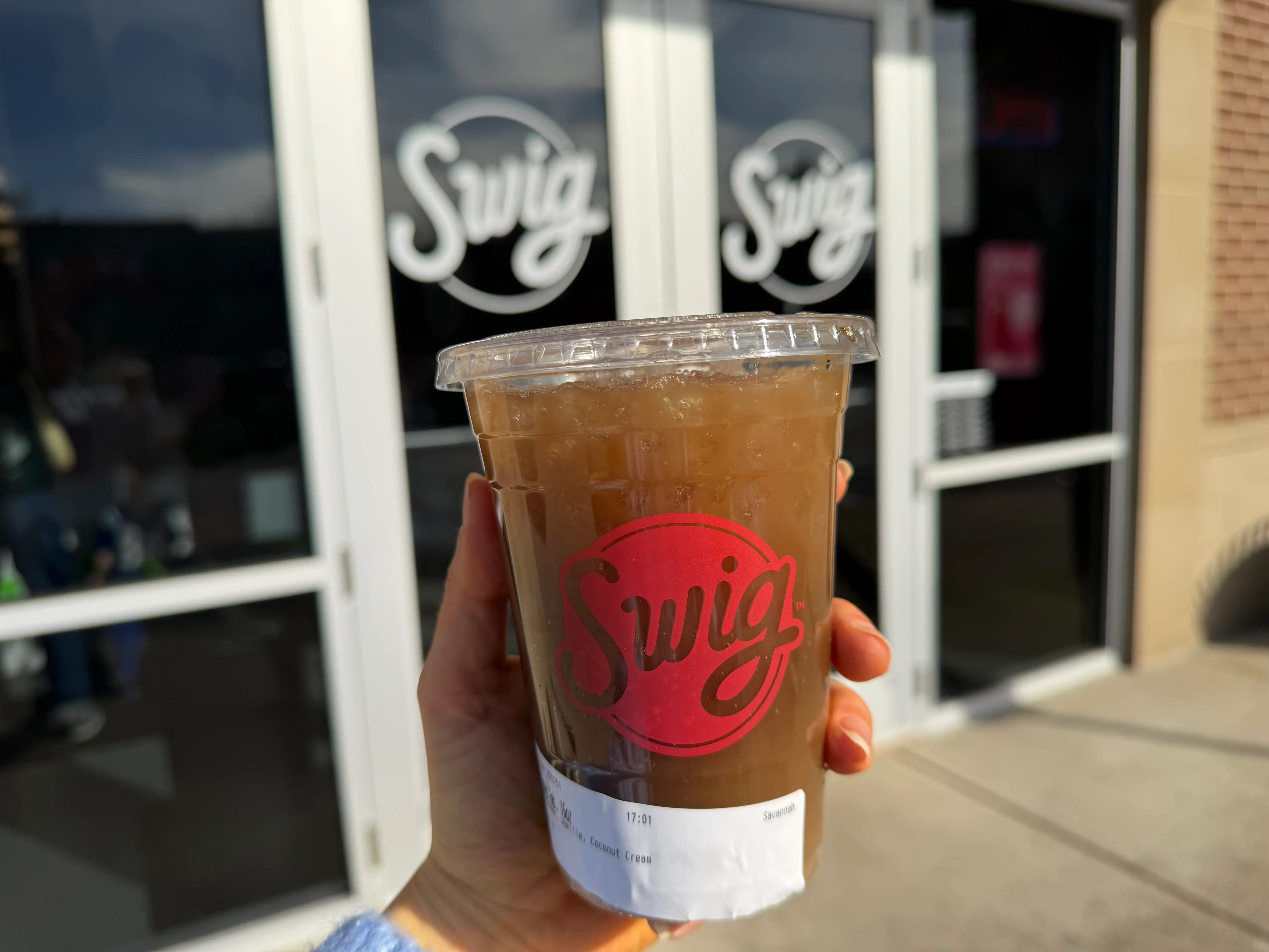 Swig Texas Tab drink in hand