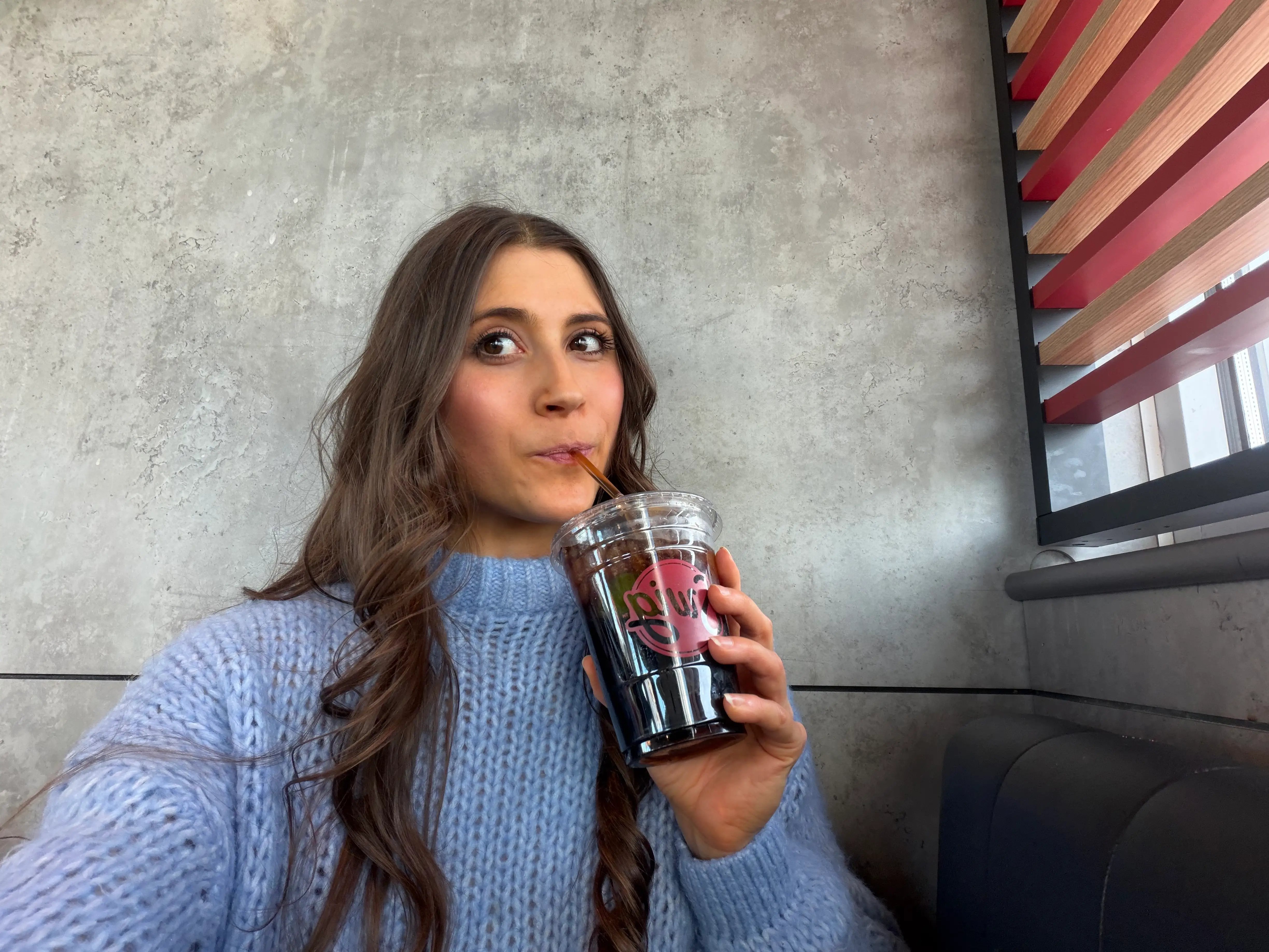 Author Savannah Born sipping a diet coke in a Swig cup