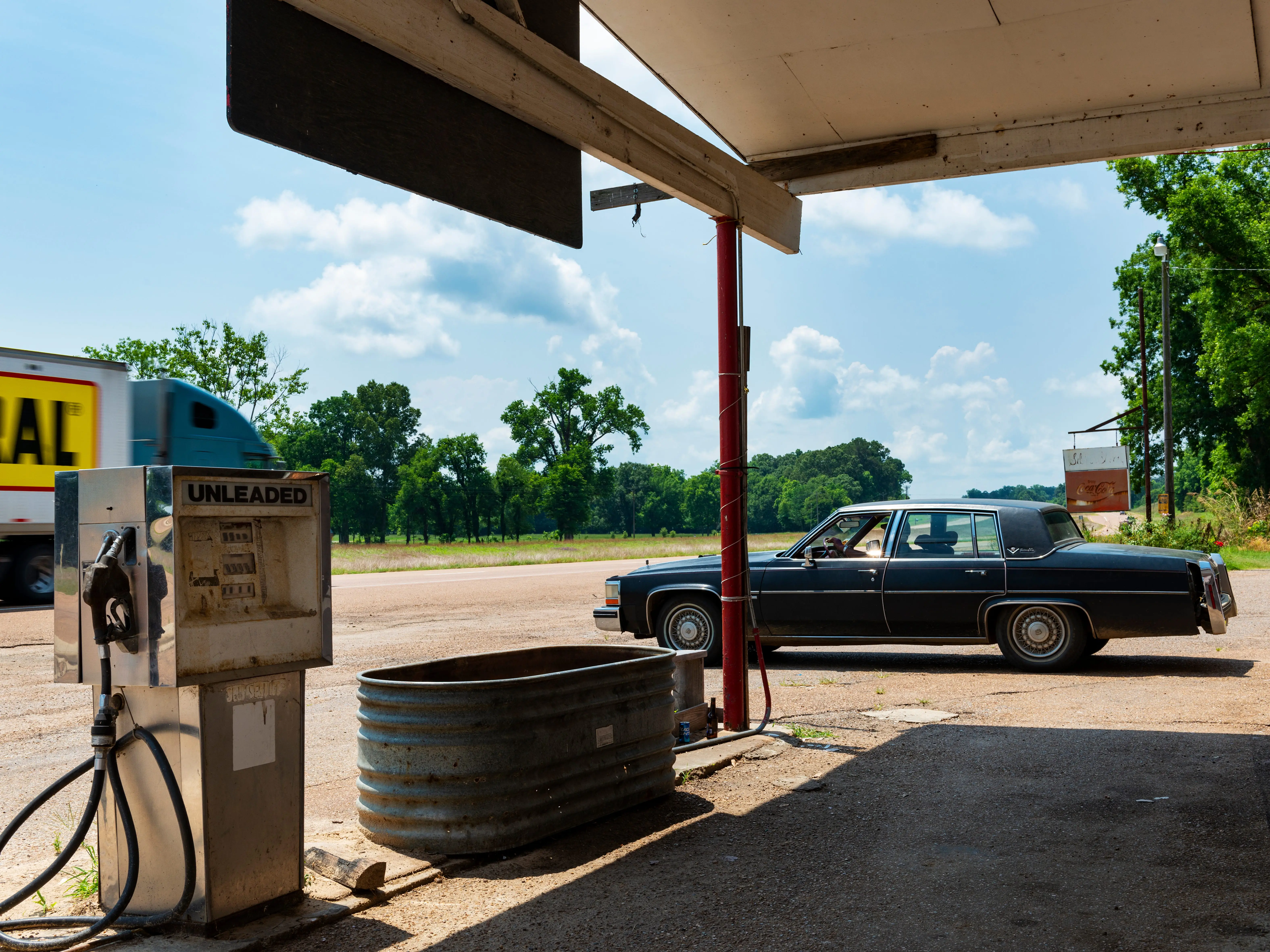 Vintage car parked next to an old gas station on Highway 61, in Sibley, Mississippi.