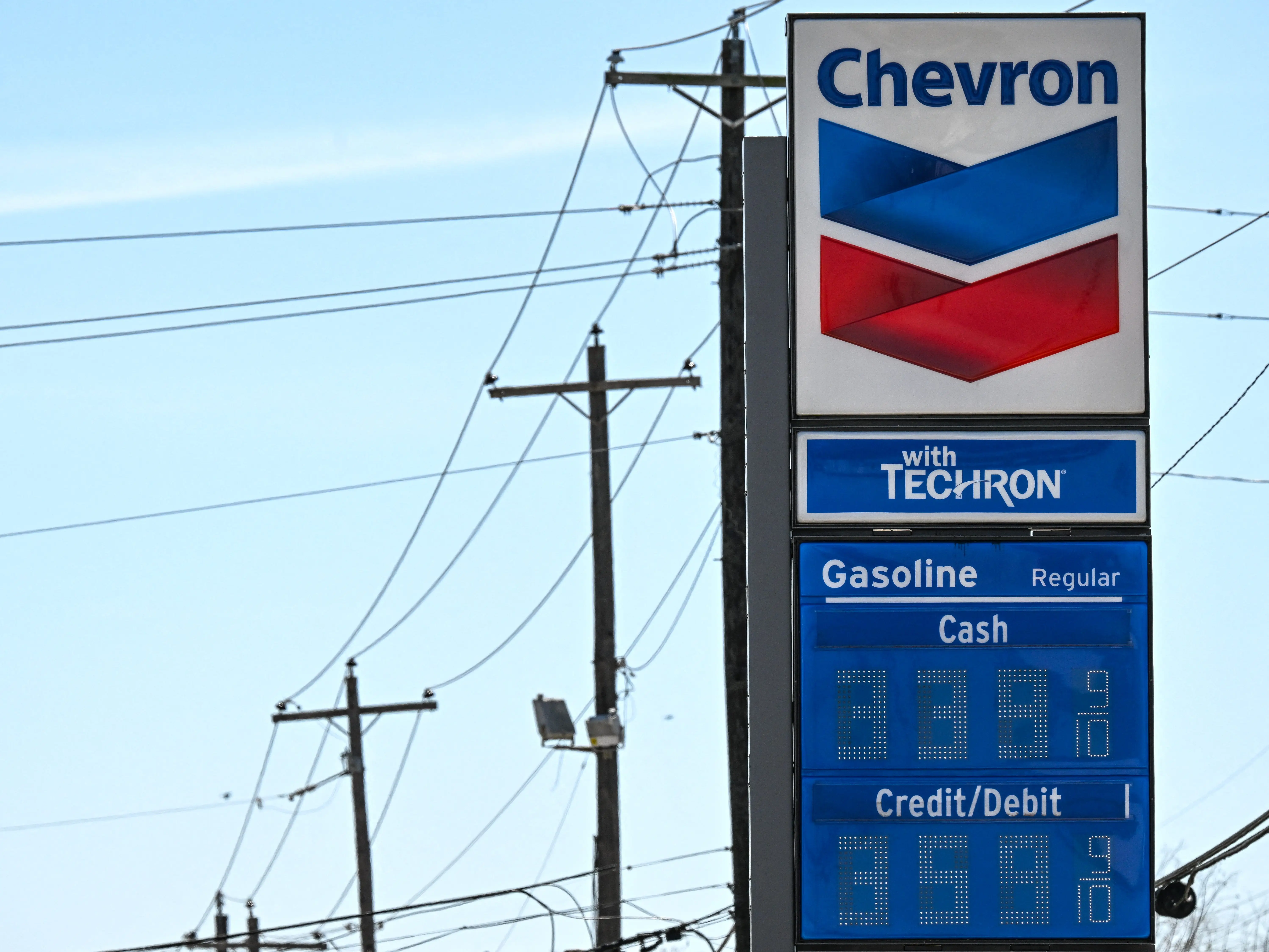 Gasoline prices are seen at a Chevron gas station in Houston, Texas, on March 16, 2026. Oil prices retreated and equities rose Monday as investors remained focused on the Strait of Hormuz, with US allies pushing back against President Donald Trump's demands to help reopen the key waterway to oil and natural gas tankers.