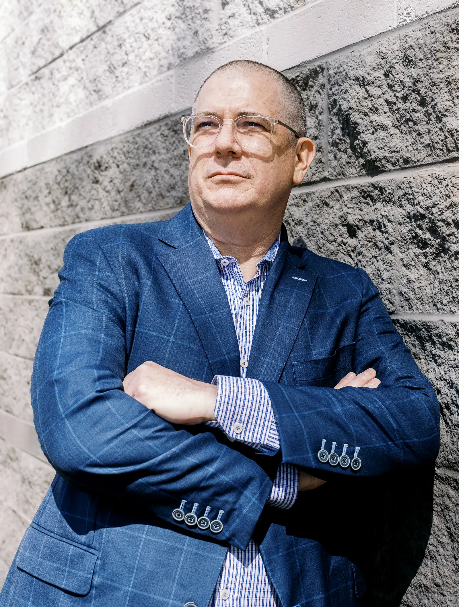 Neon One CEO Keith Reed standing against a wall.