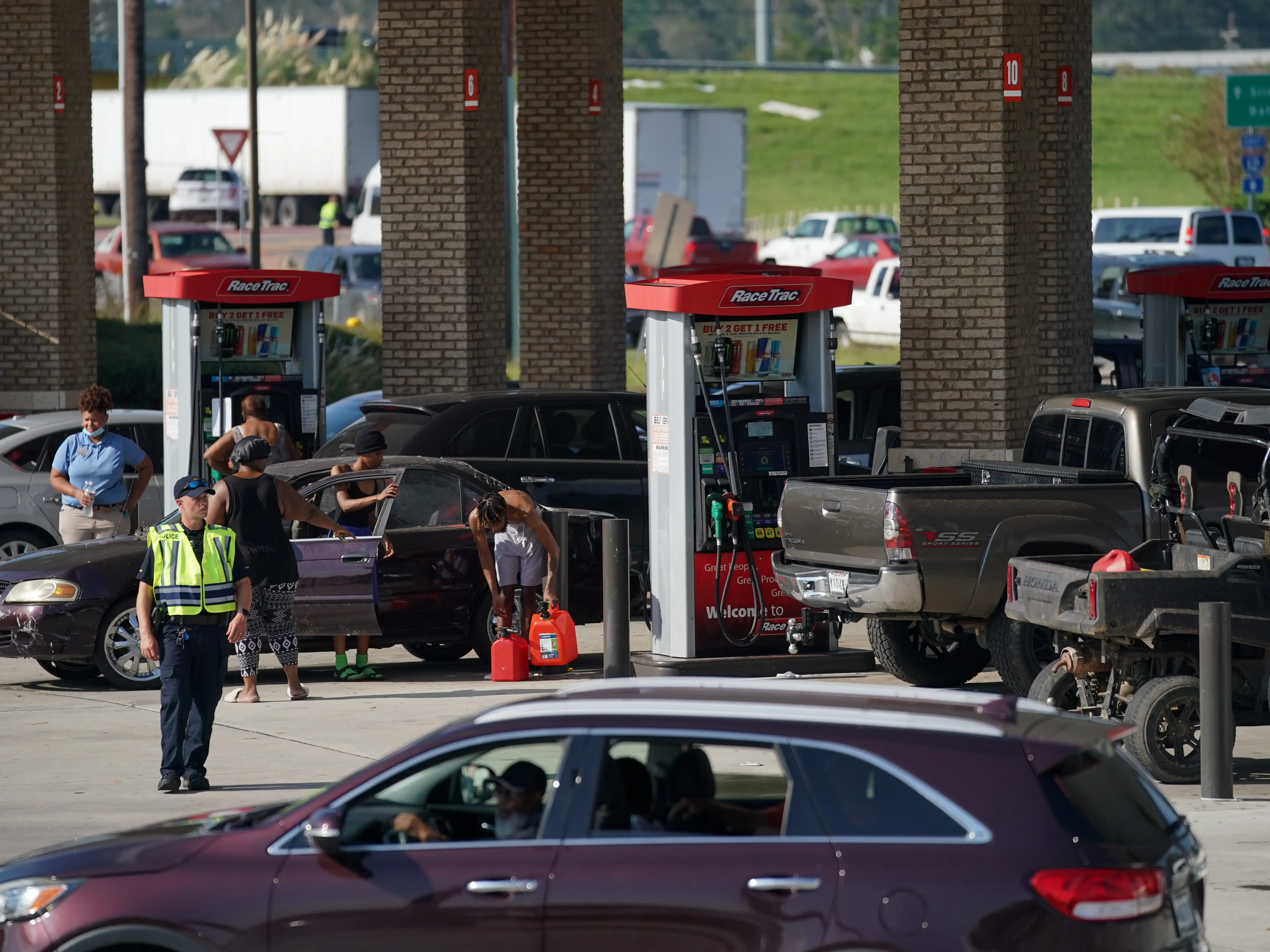 People get gas at a fueling station along Interstate 12 on September 1, 2021 in Hammond, Louisiana. Tropical Storm Ida made landfall as a Category 4 hurricane Sunday in Louisiana and brought flooding, wind damage and power outages along the Gulf Coast