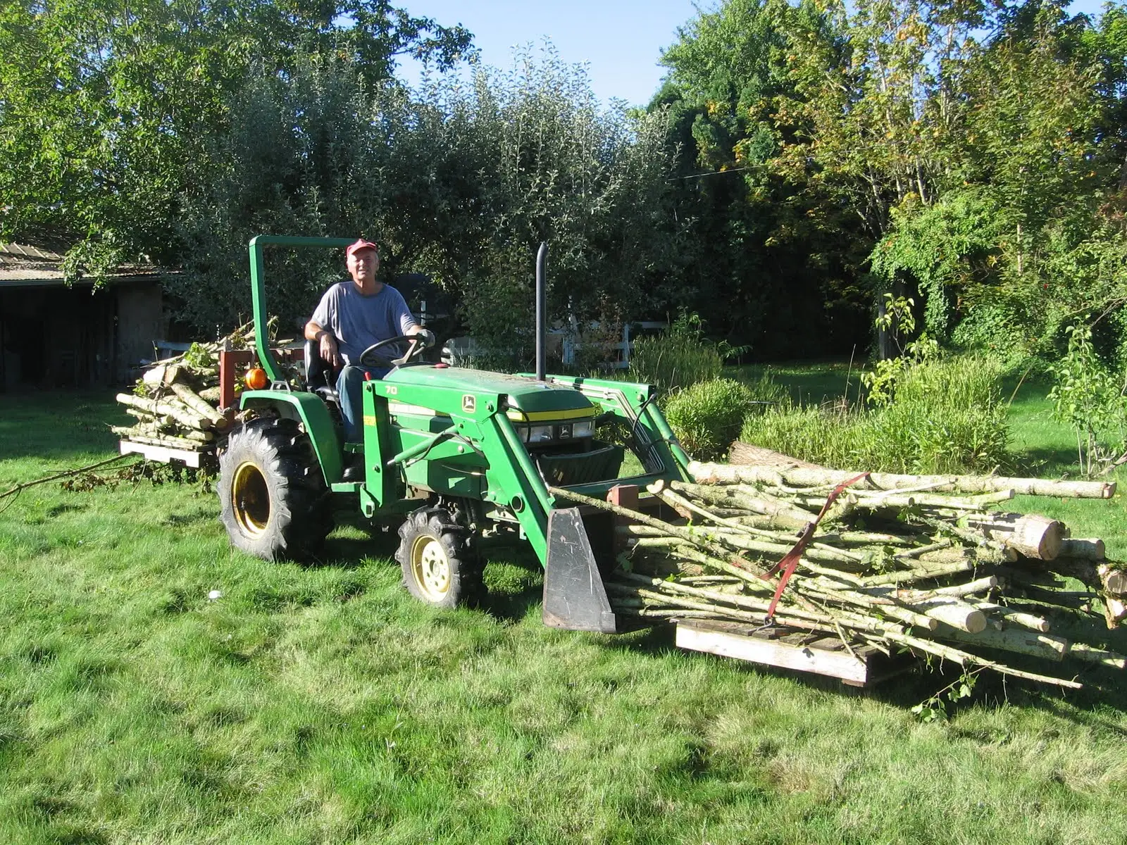 Cynthia Wall's husband sitting on a tractor