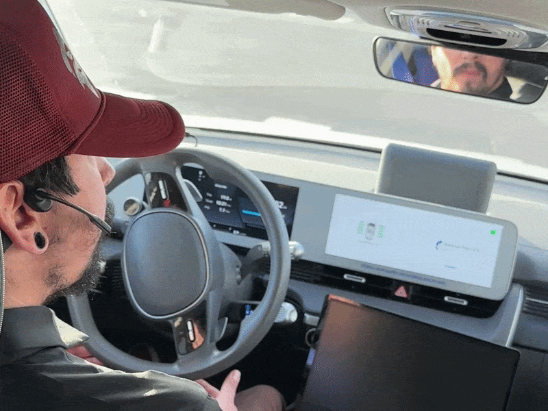 A driver behind a steering wheel that moves by itself.