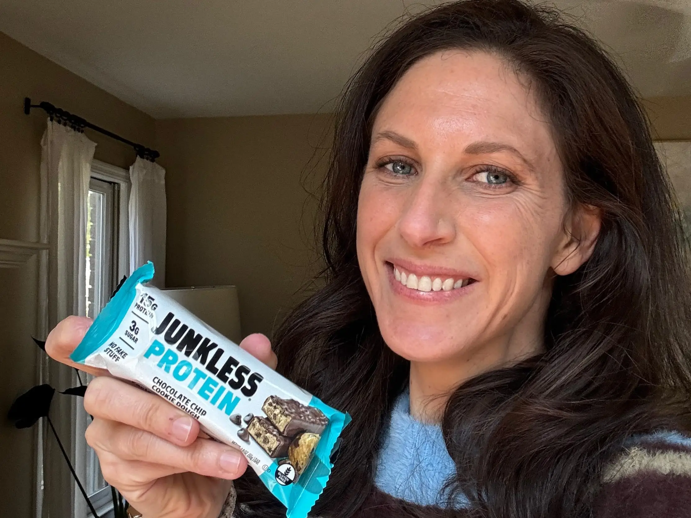 Lauren Manaker holding Junkless Protein Granola Bar