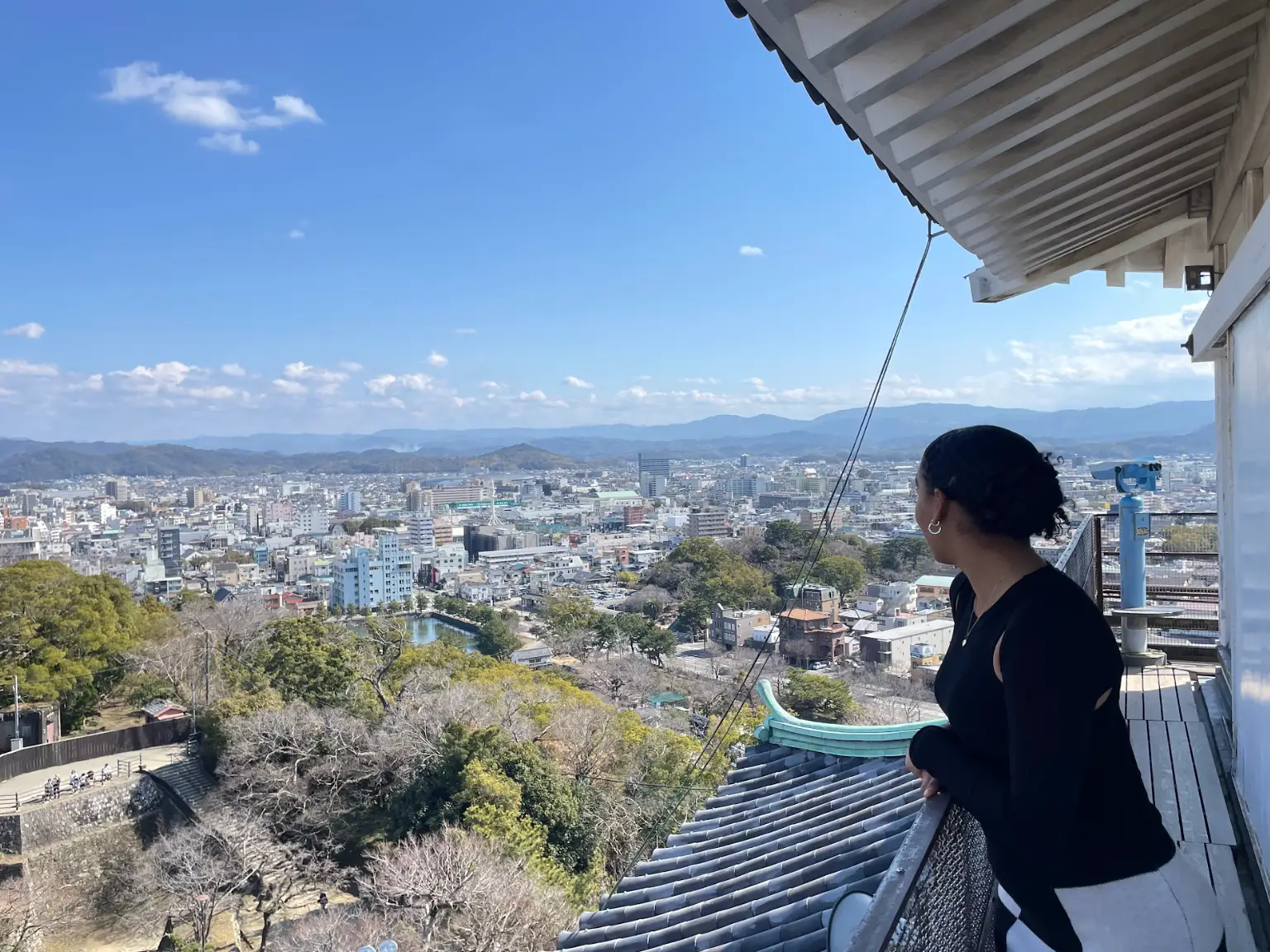 The writer looking out at buildings in Wakayama, Japan.