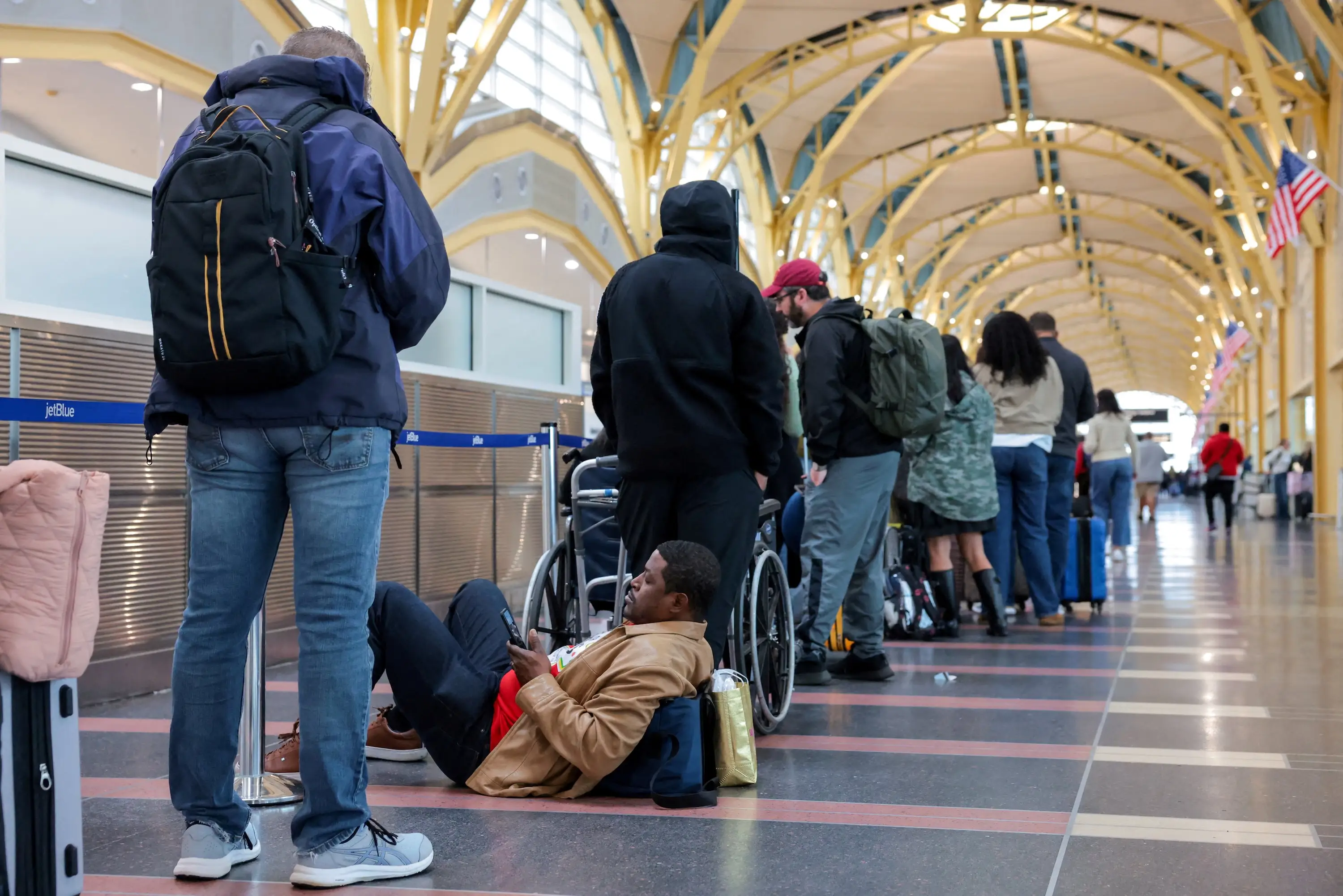 Passengers wait in a check-in line at Ronald Reagan Washington National Airport.