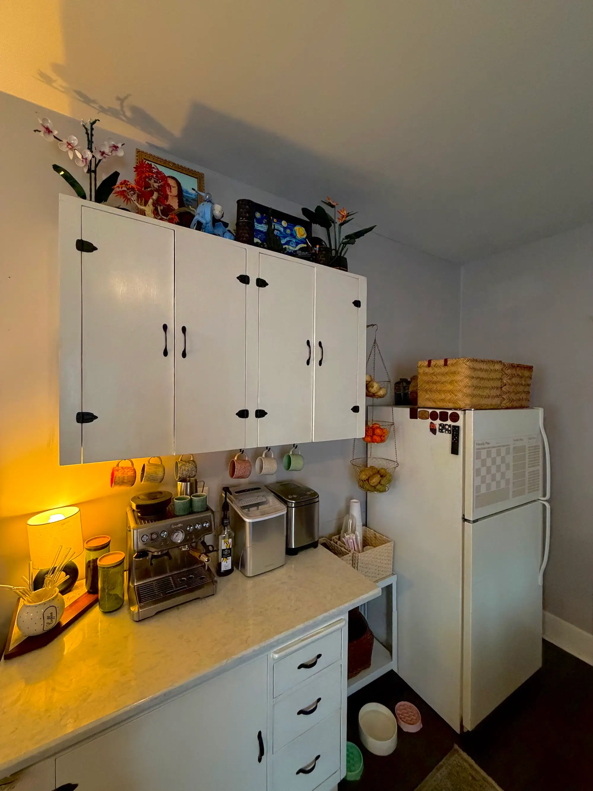 A kitchen with a countertop and a refrigerator.