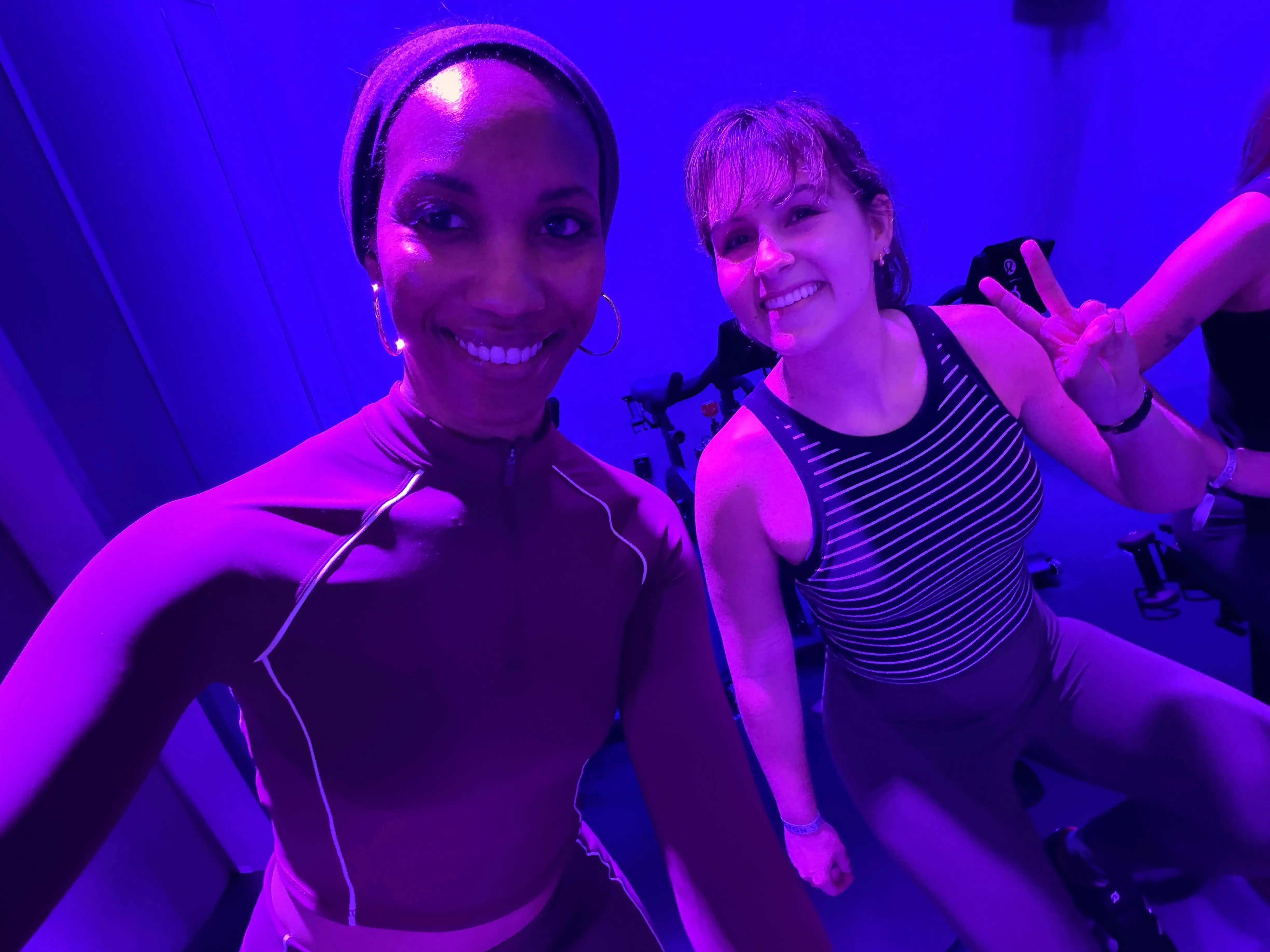 Two women in a Peloton class