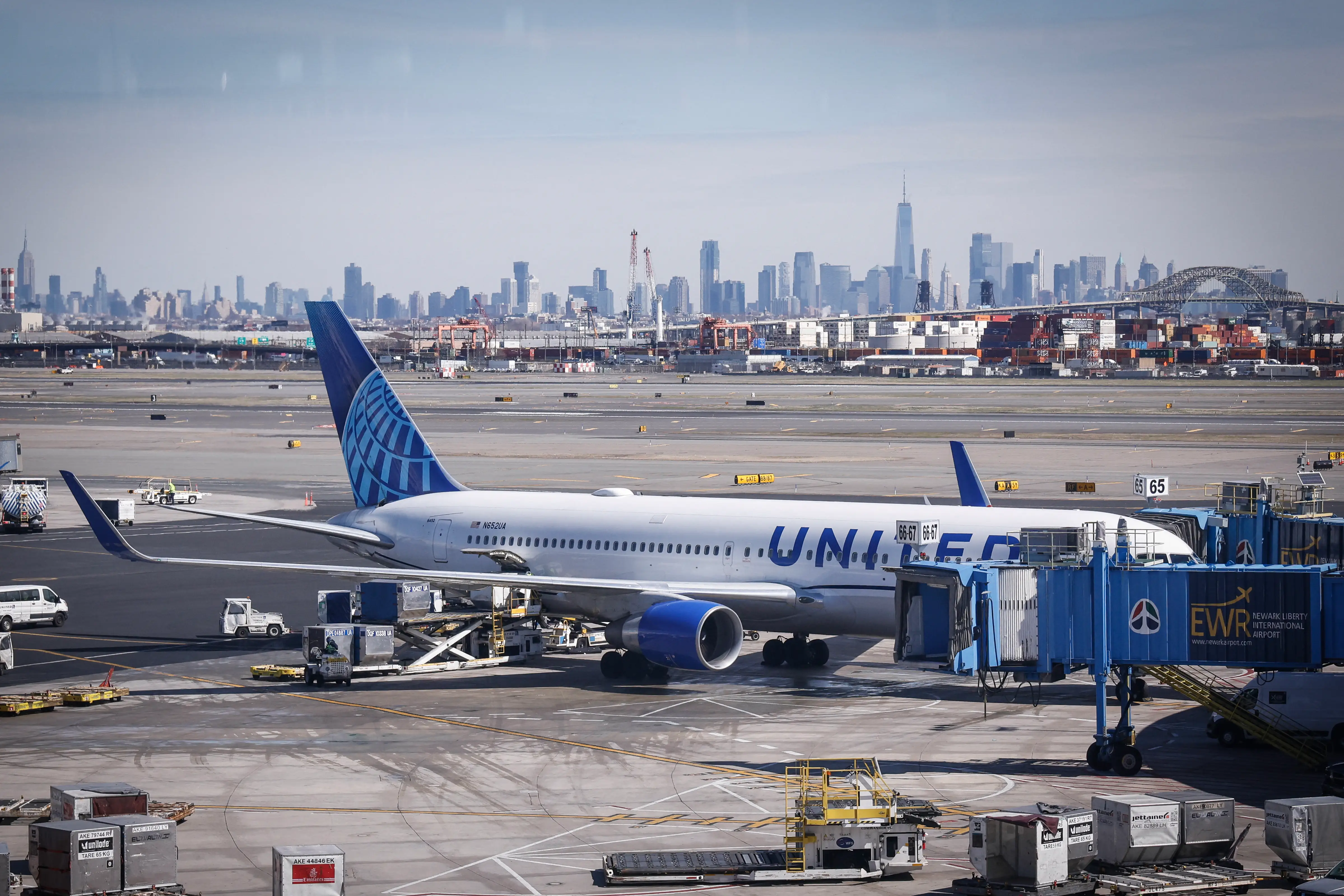 A United Airlines 767-300ER is seen at a gate with the Manhattan skyline in the background at Newark Liberty International Airport in Newark, New Jersey, on March 18, 2026