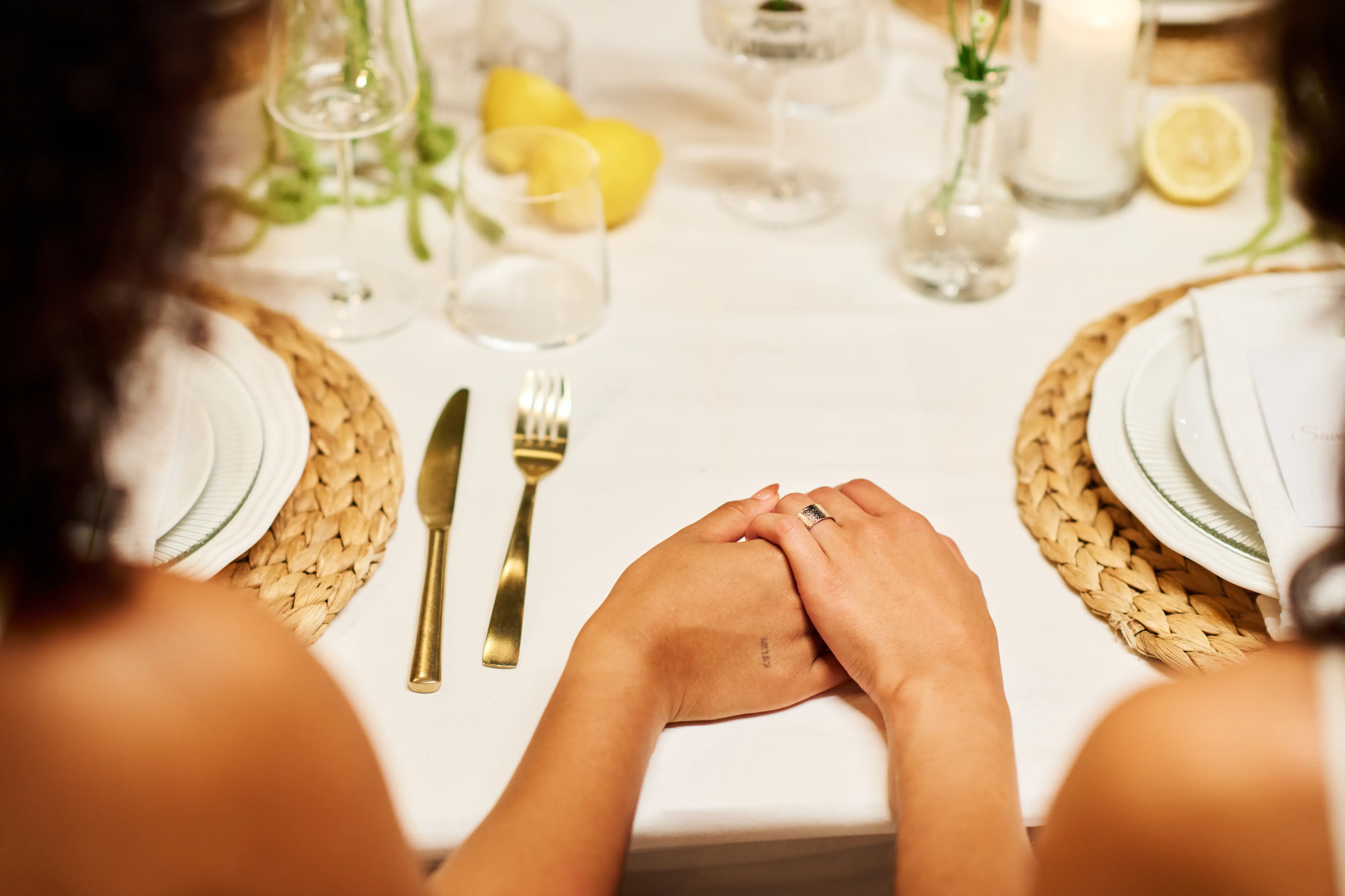 Couple holding hands at table