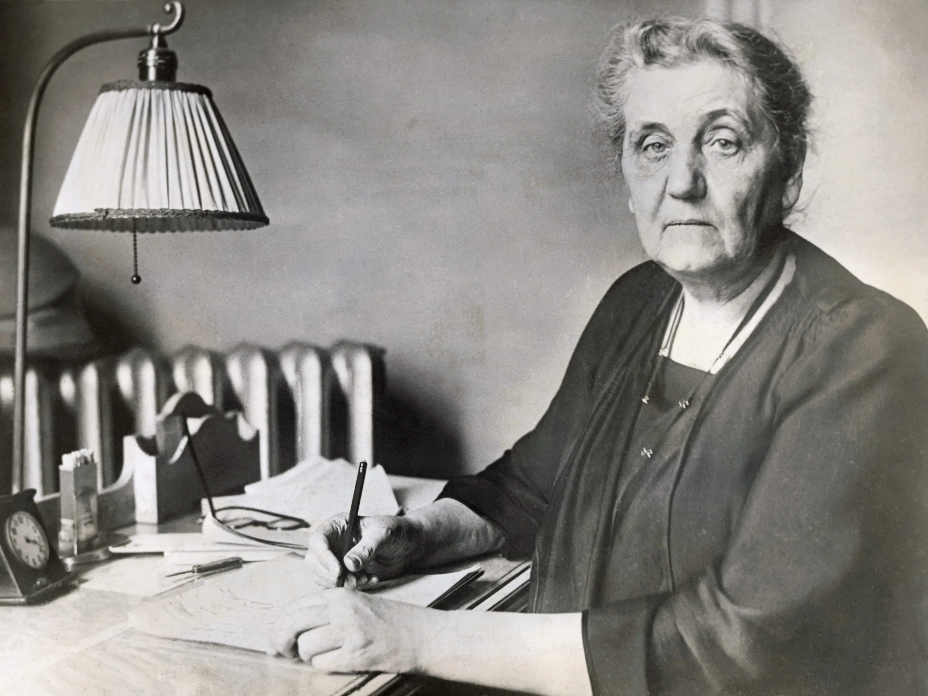 Jane Addams writing at her desk.