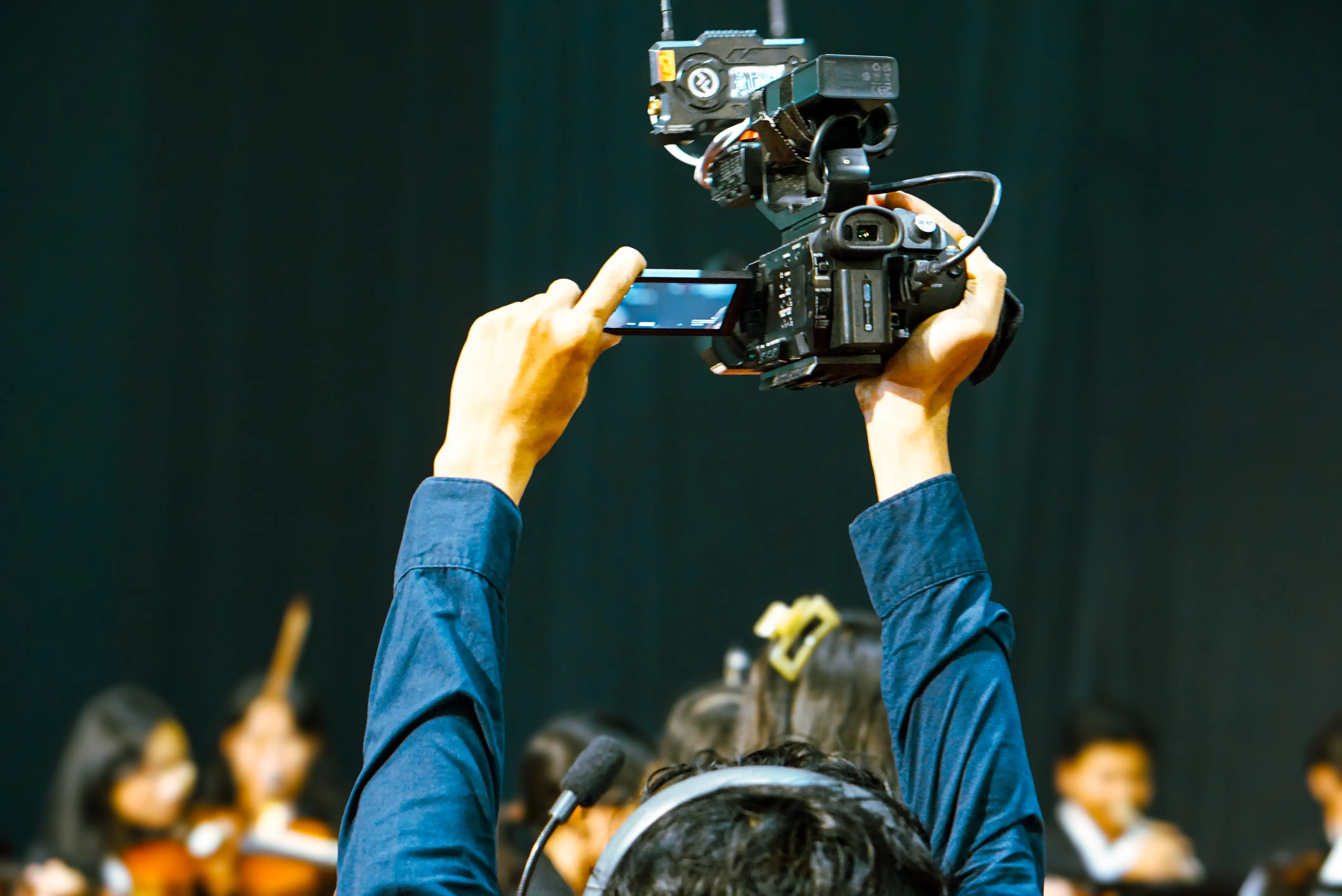 A college students holds a video camera