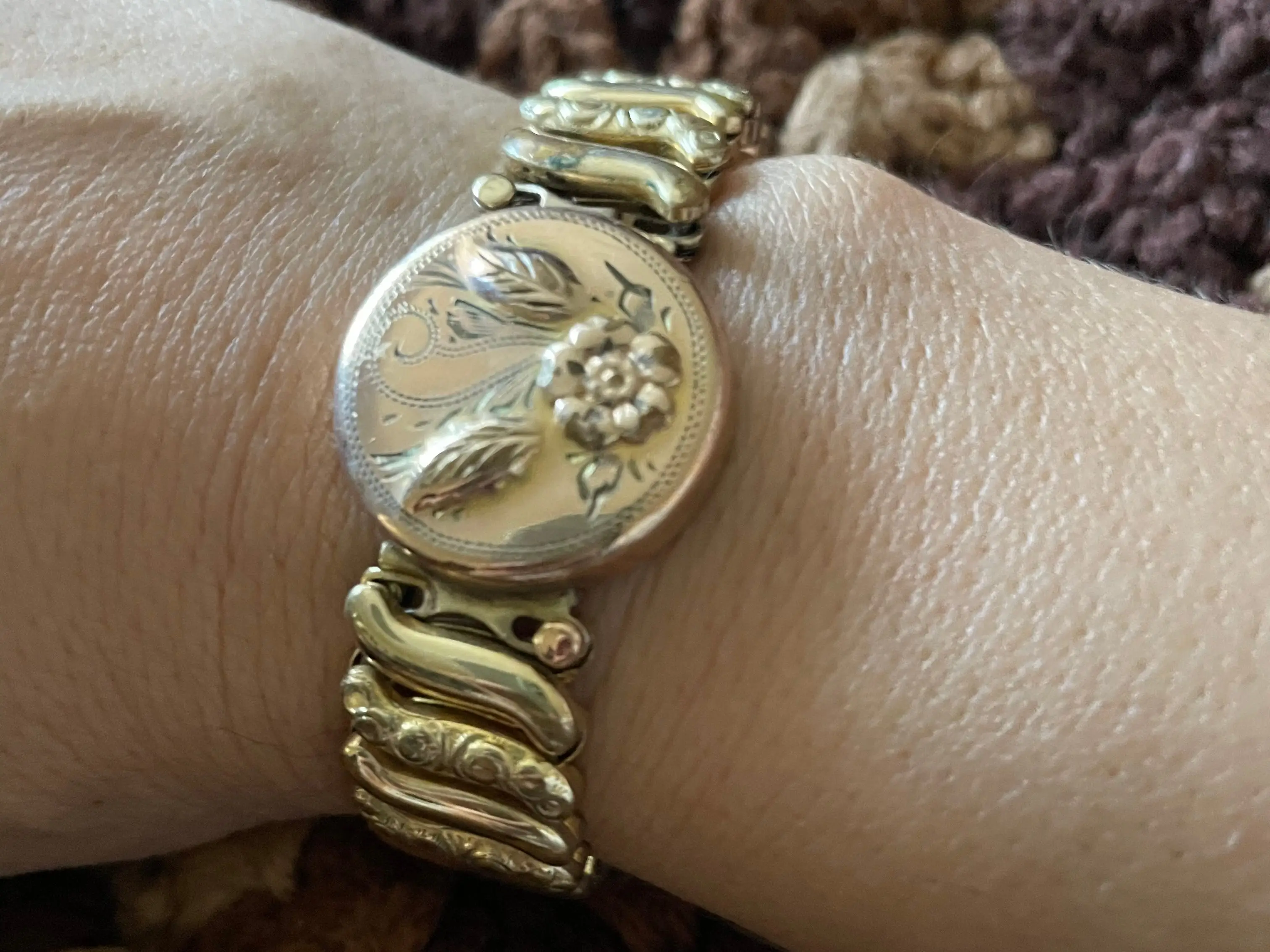 A woman models an heirloo bracelet she inherrited.