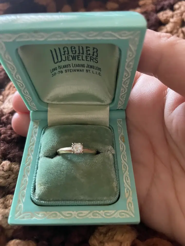 The author holds an engagement ring in a turquoise box that she inherited from her grandmother.