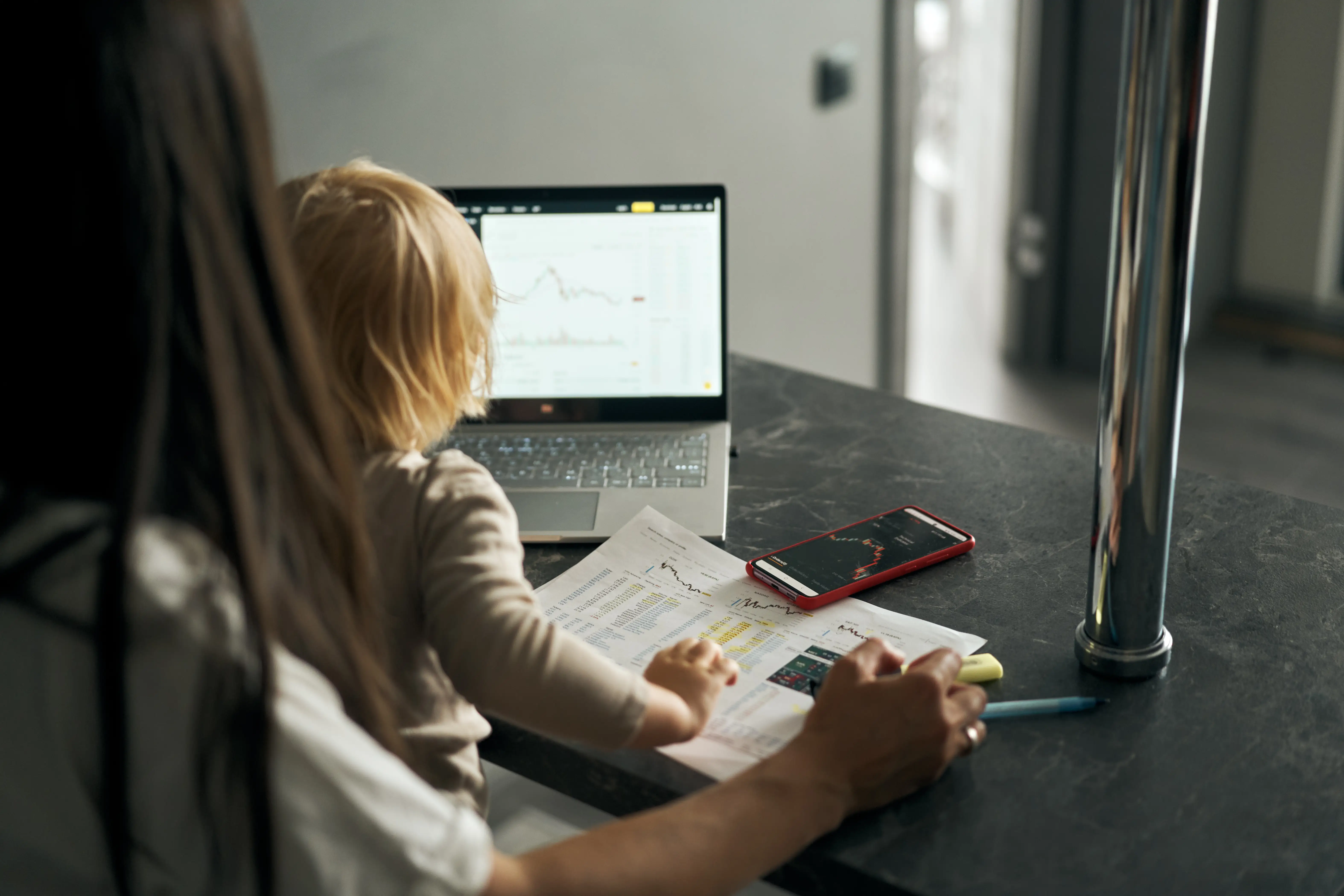 A working woman holding a baby in her lap.