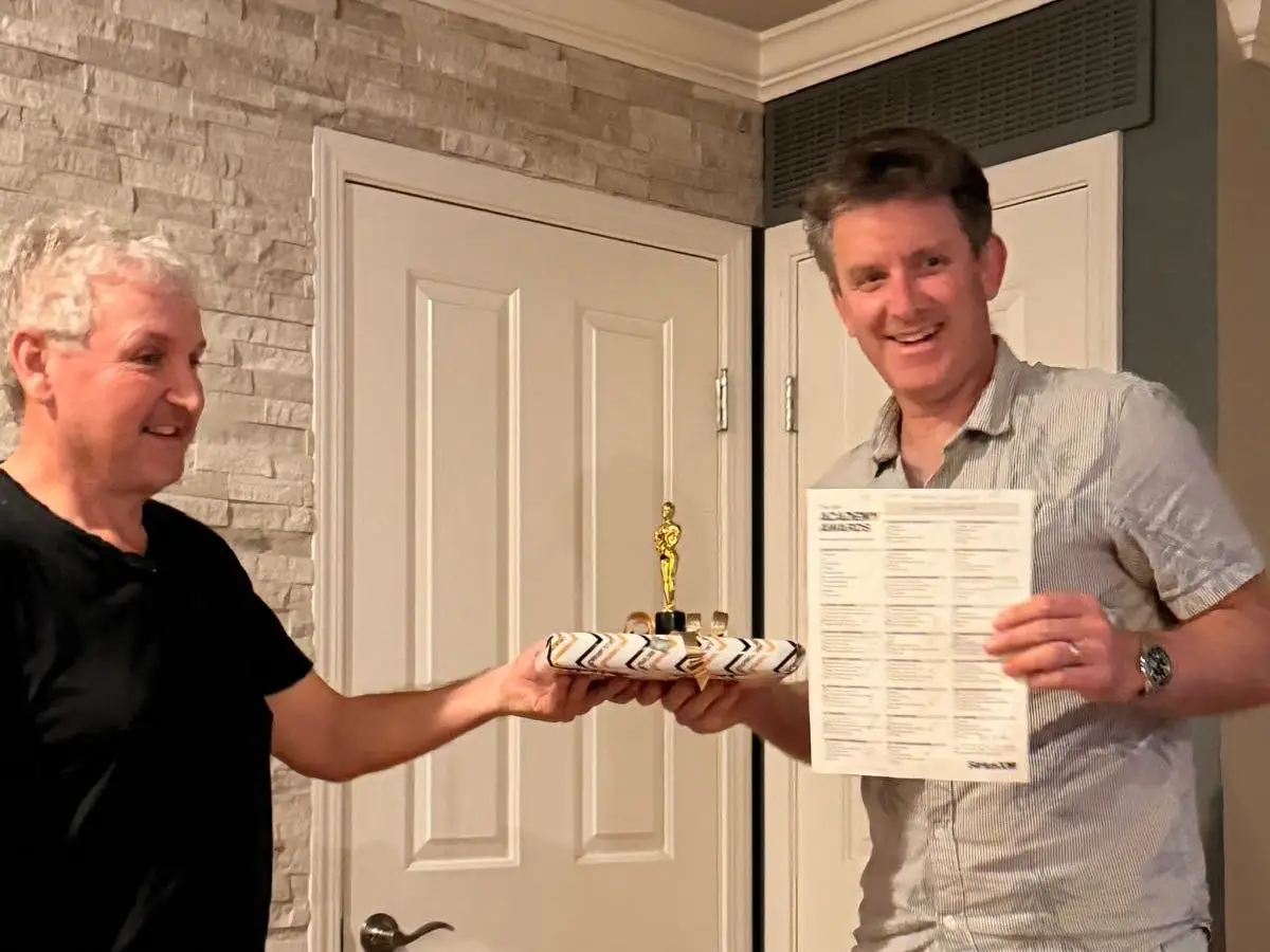 Alistair Barr (right) winning the Oscar ballot at a friend's party