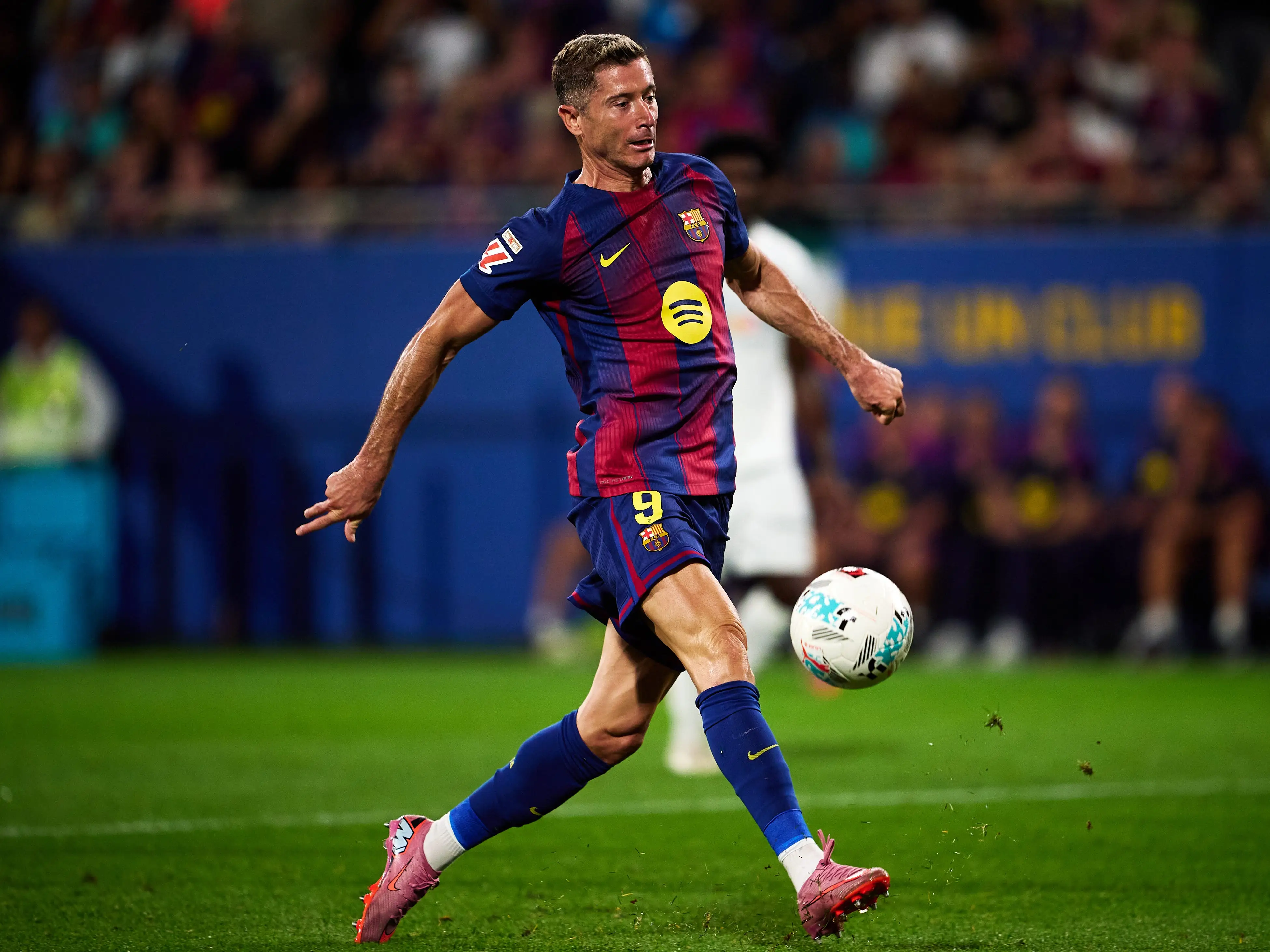 Polish soccer player Robert Lewandowski shooting a soccer ball.