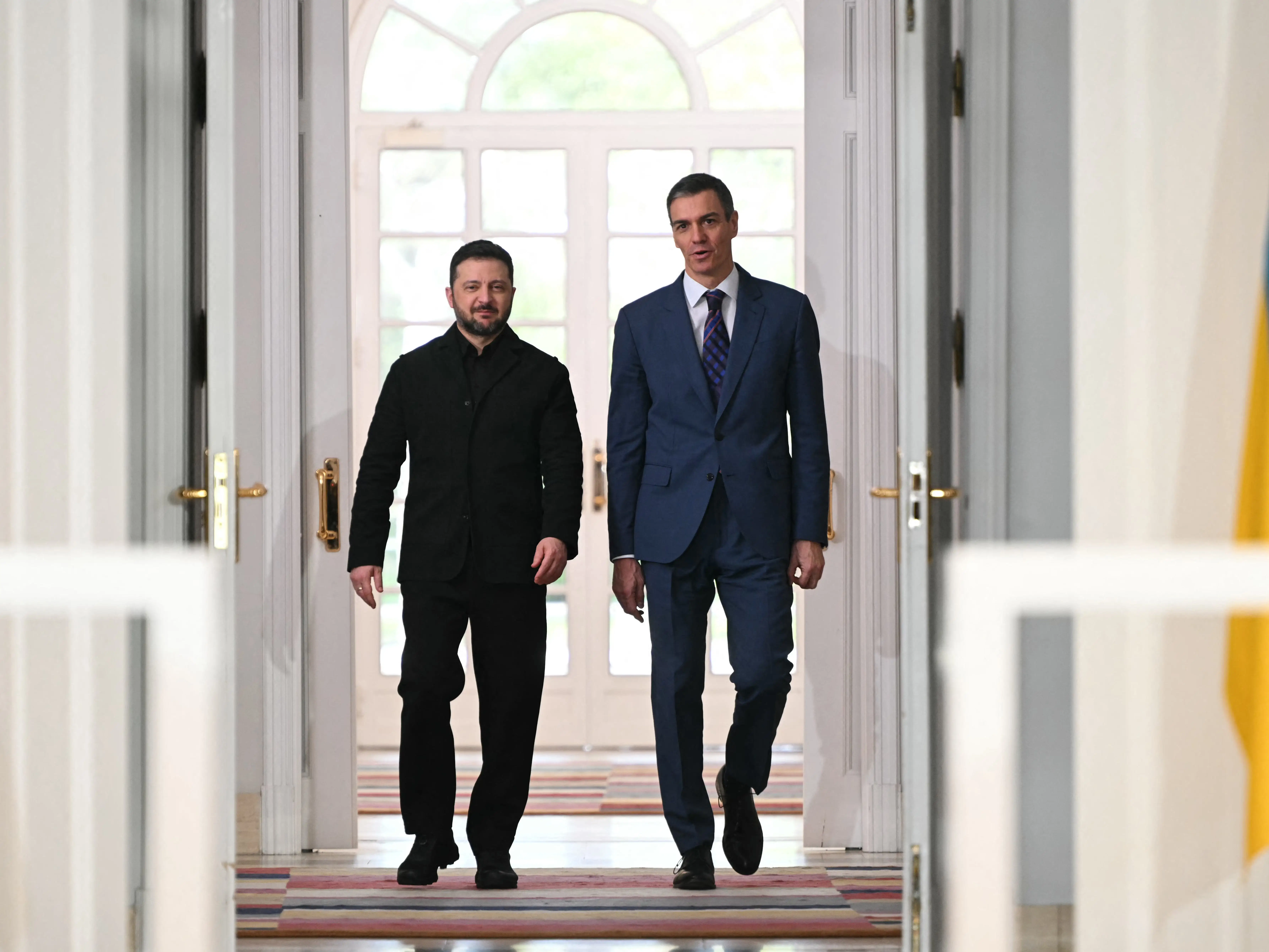 Ukrainian president Volodymyr Zelenskyy walks next to Spain's Prime Minister Pedro Sanchez.