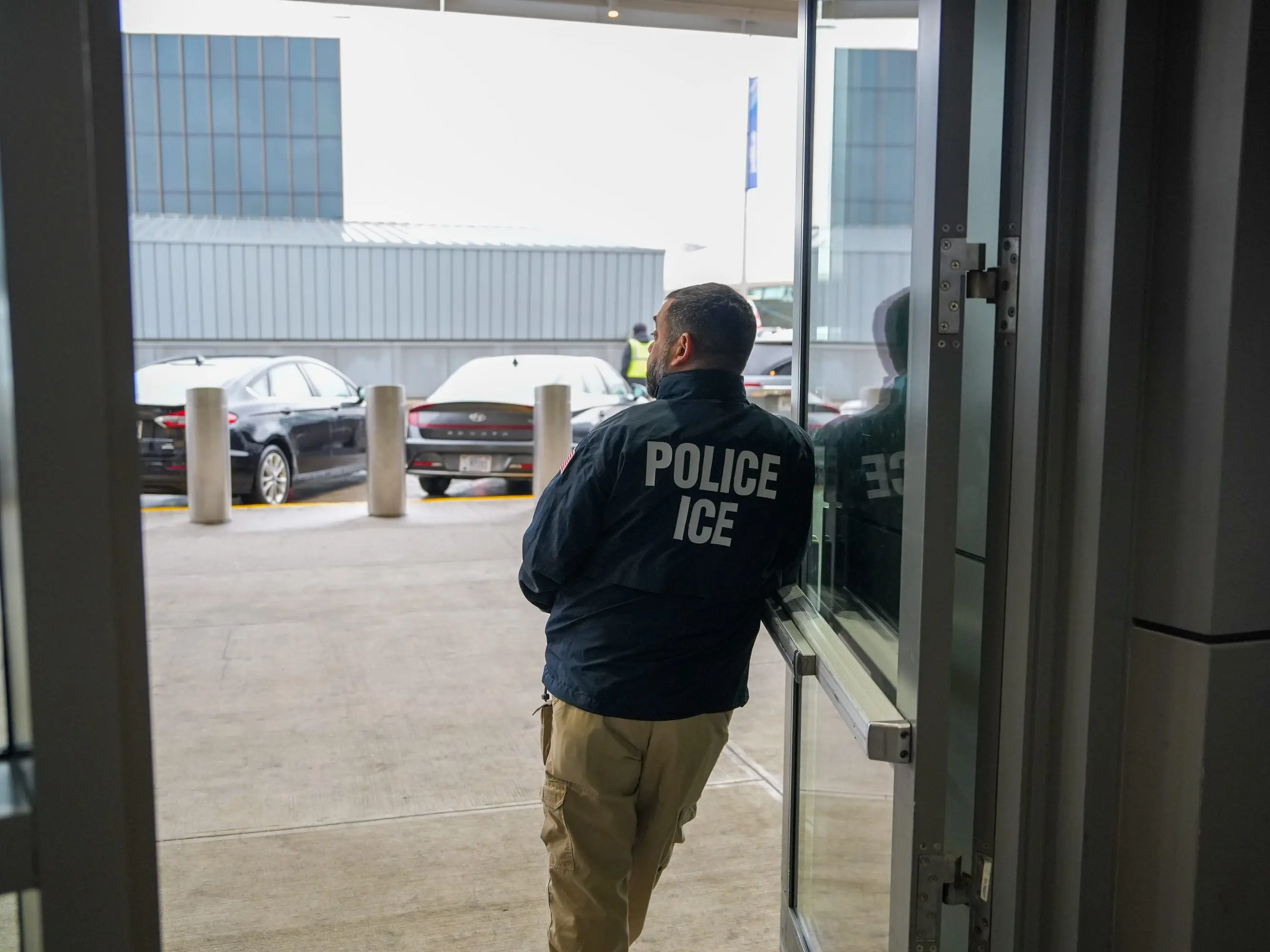 A U.S. Immigration and Customs Enforcement (ICE) agent stands at John F. Kennedy International Airport (JFK) in the Queens borough of New York, Monday, March 23, 2026.