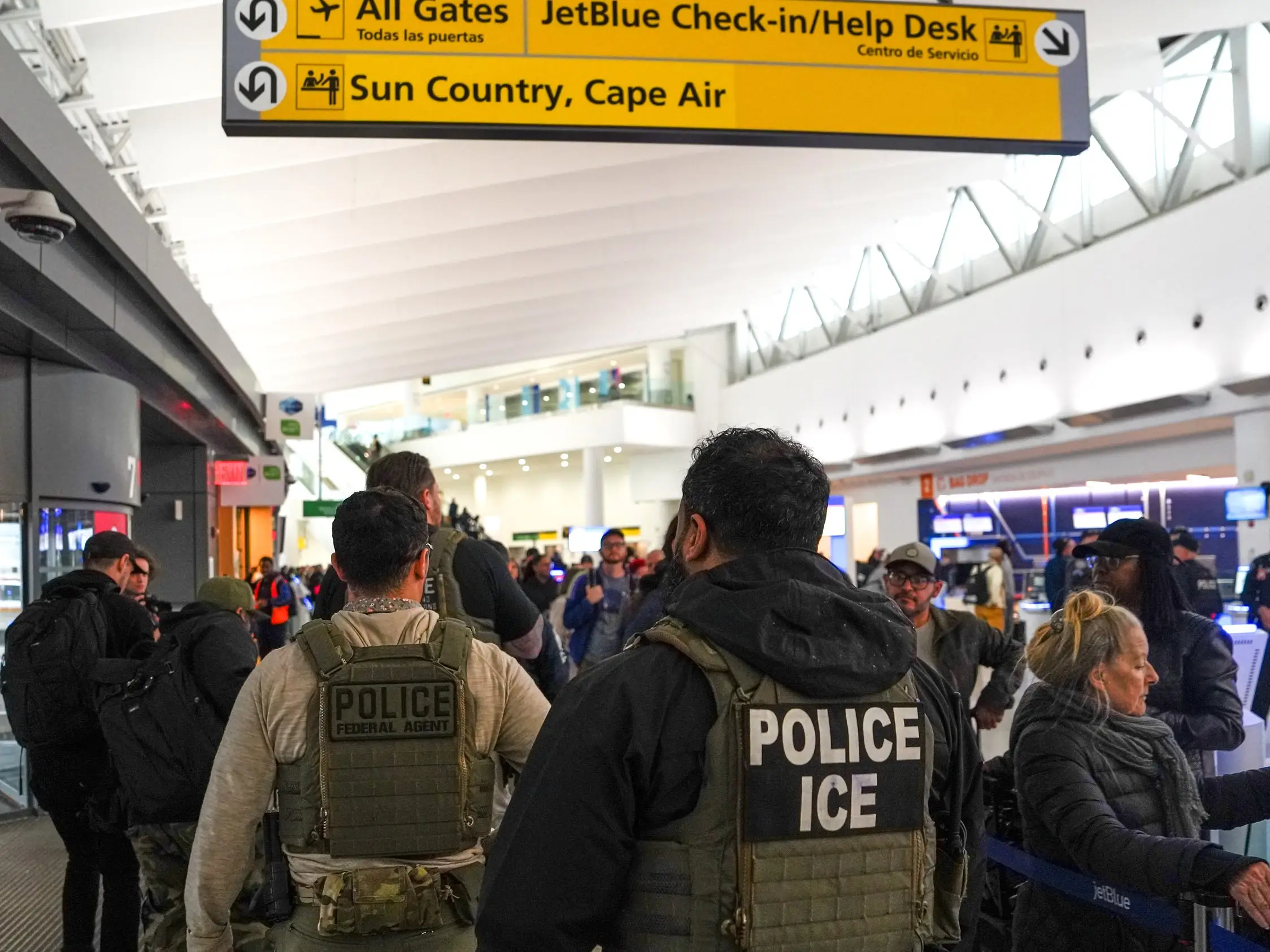 Federal immigration agents walk through Terminal 5 at John F. Kennedy International Airport (JFK) in the Queens borough of New York, Monday, March 23, 2026.