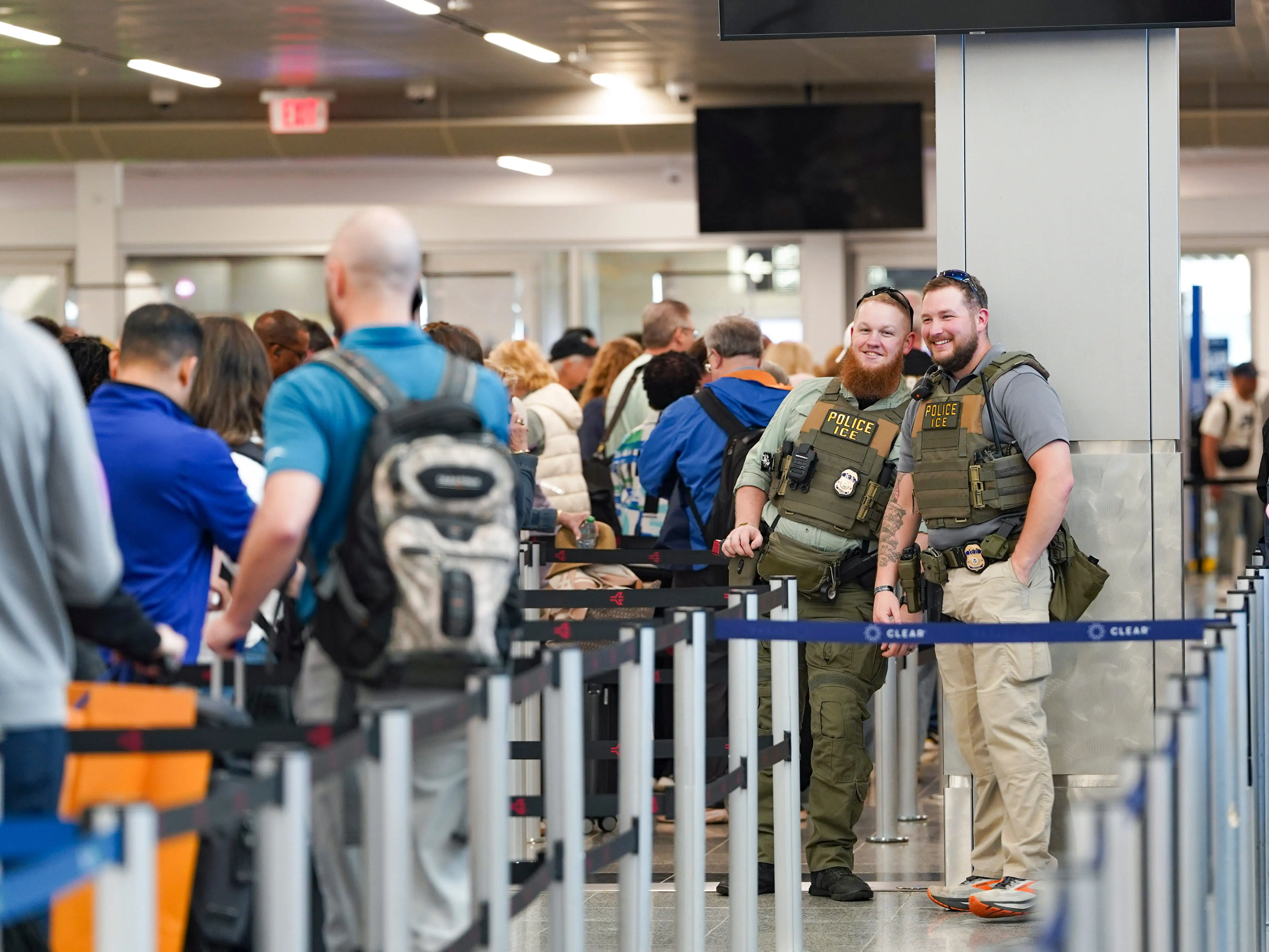 ICE agents stand next to the security line at Atlanta Hartsfield-Jackson International Airport on March 23, 2026 in Atlanta, Georgia.