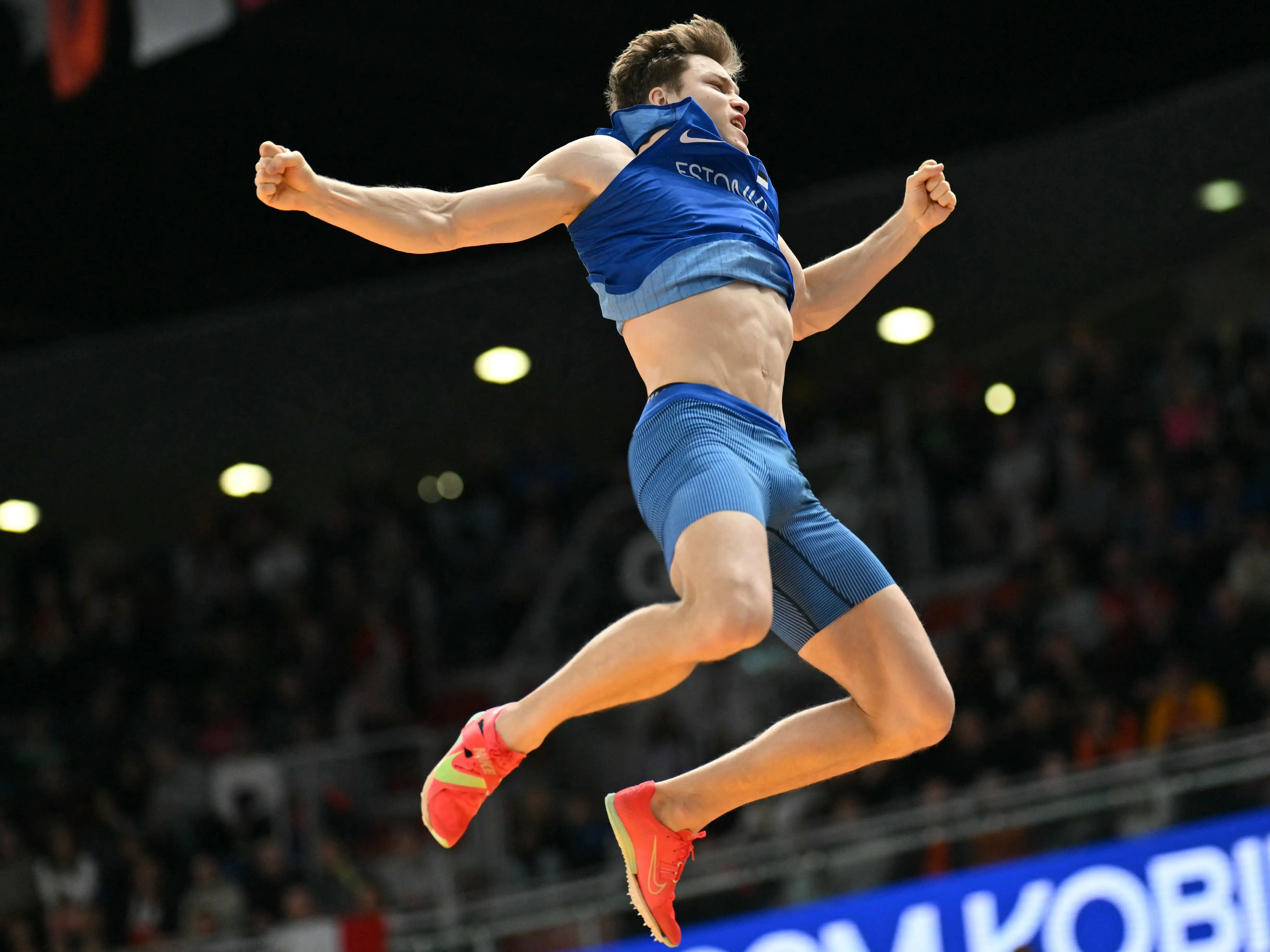 Estonian athlete Rasmus Roosleht in midair during a pole vault.