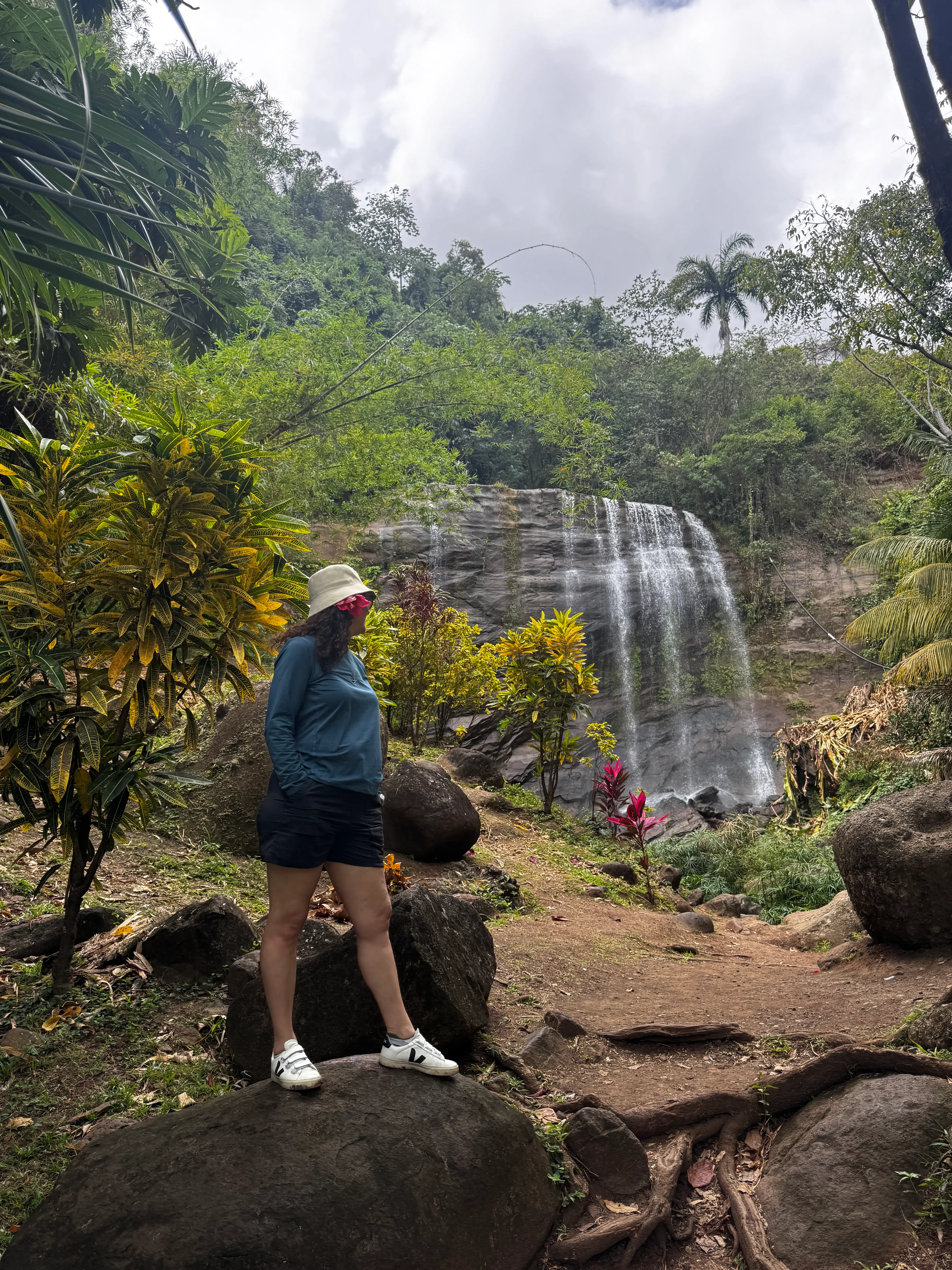 Jamie Davis Smith in front of a waterfall in grenada