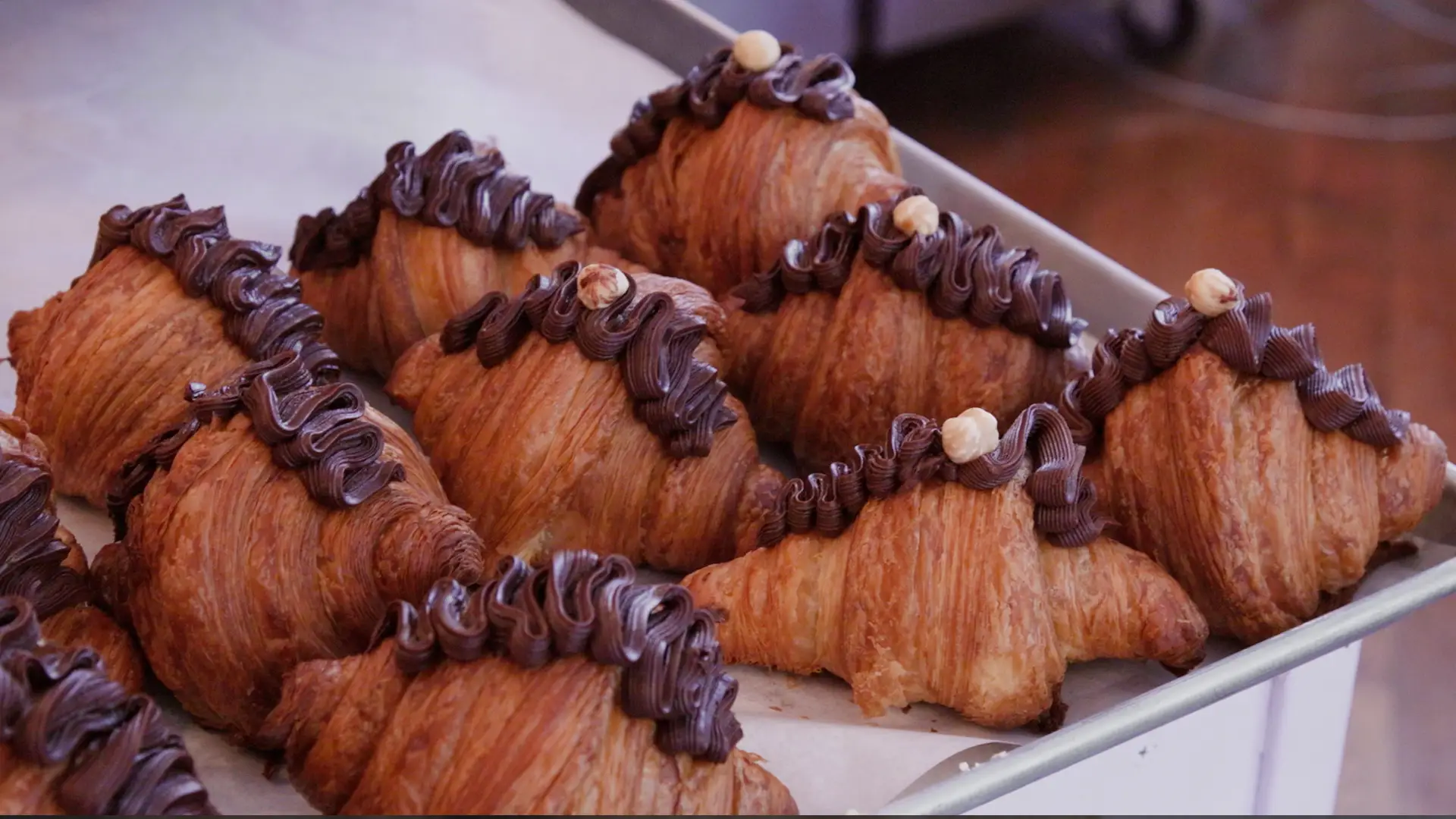 Croissants with chocolate icing on top.