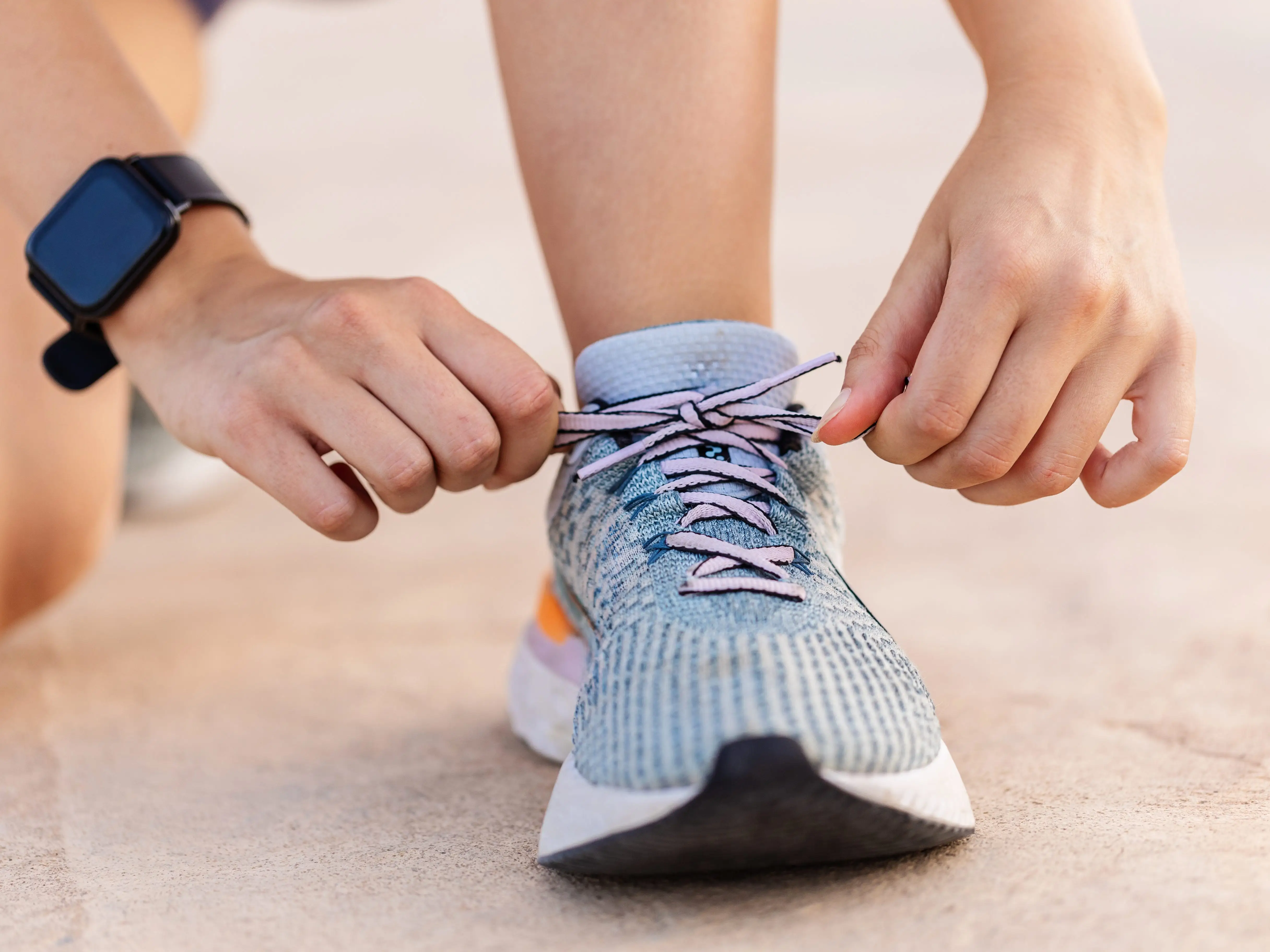 Person lacing sneakers