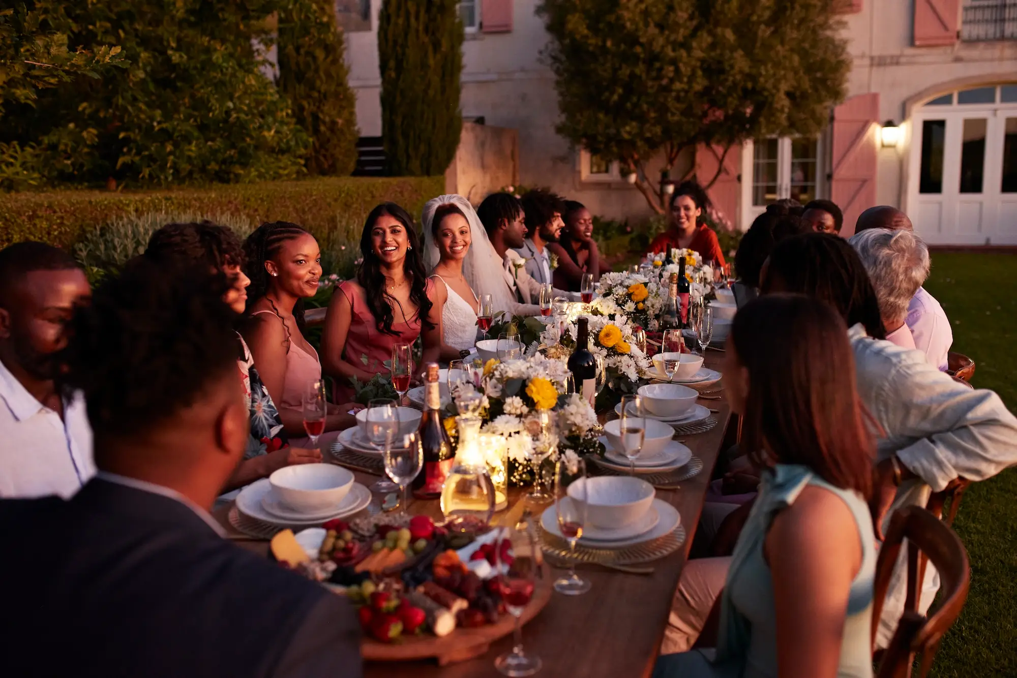A wedding celebration at a long table at a vineyard.