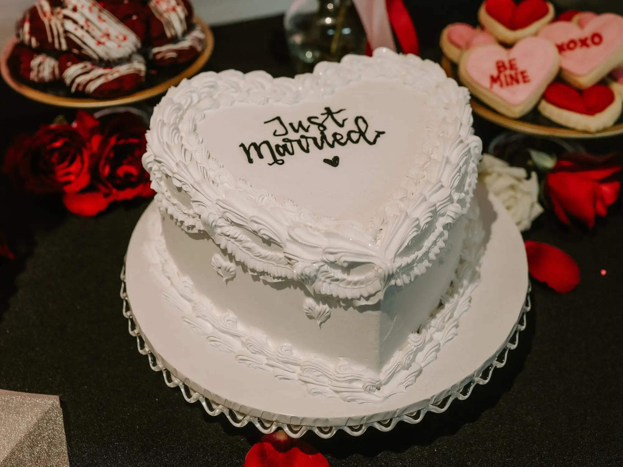 A heart-shaped wedding cake that says 