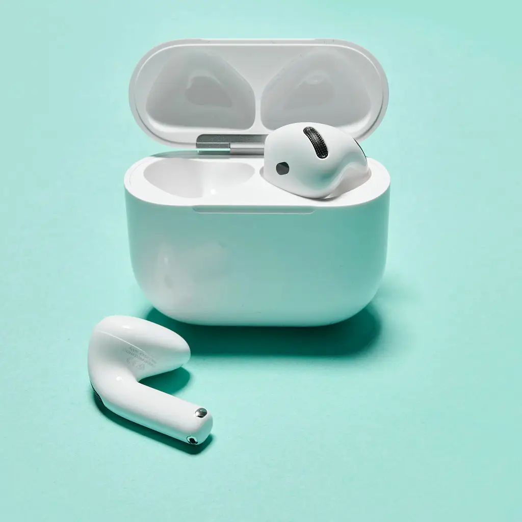 airpods ina case against green background