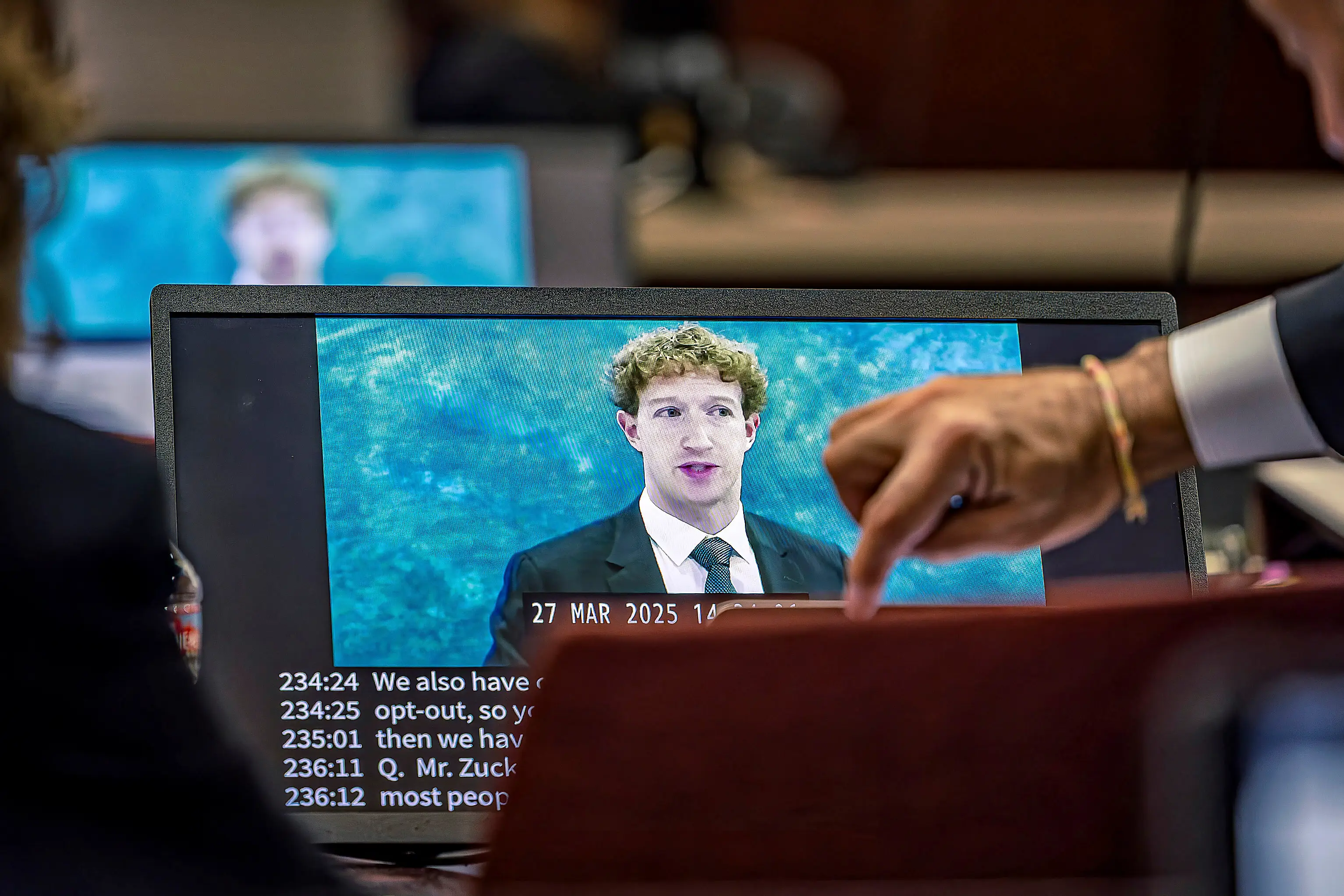 Lawyers for the plaintiff watch on a laptop as a recording of Meta Founder and CEO Mark Zuckerberg's deposition is played for the jurors on Wednesday, March 4, 2026, in Santa Fe, N.M. (Jim Weber/Santa Fe New Mexican via AP, Pool)