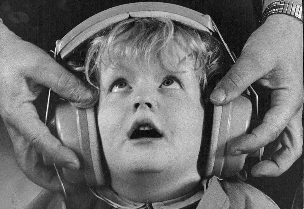 black and white photo fo a child in headphones
