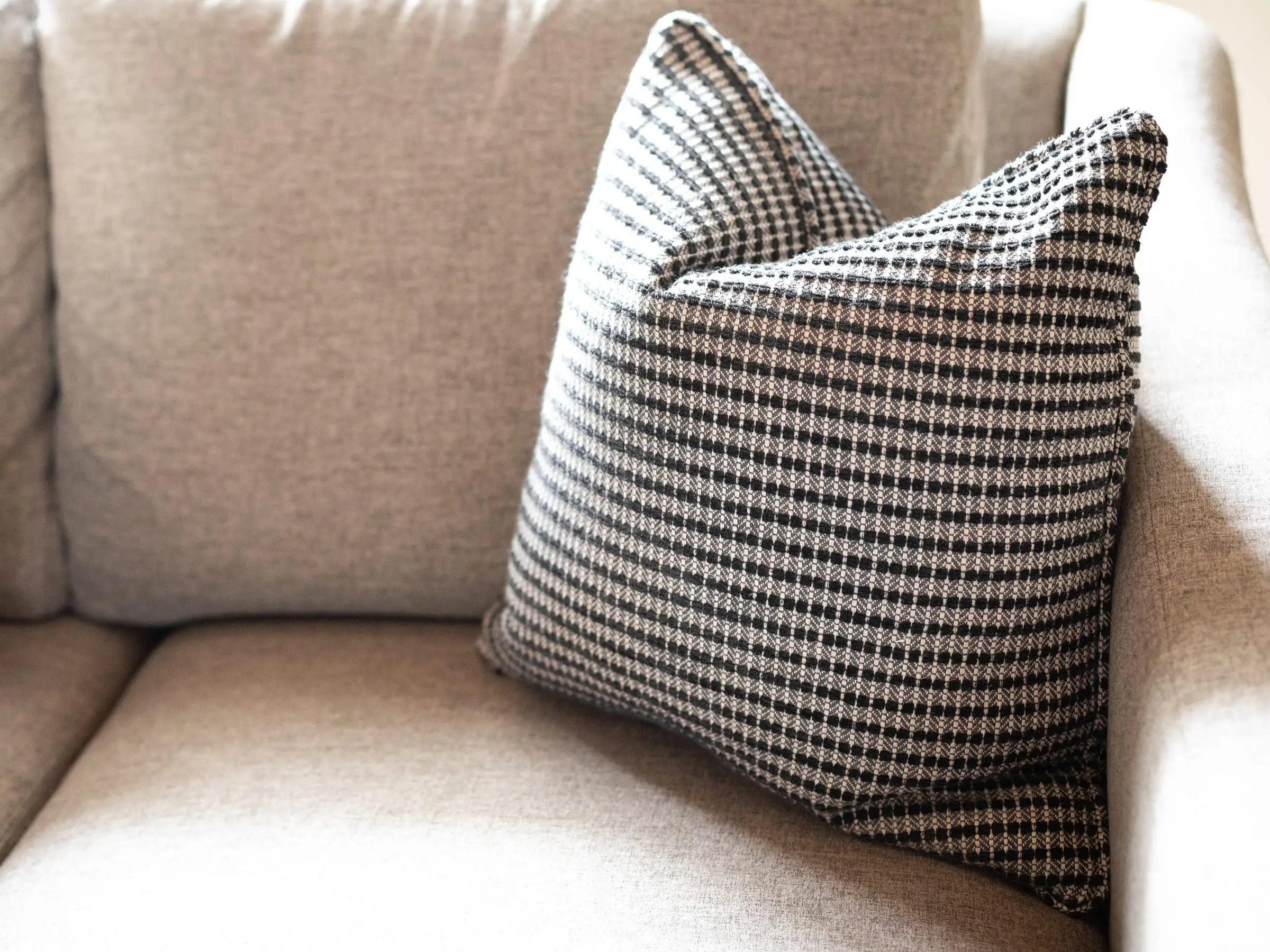 Checkered pillow on couch