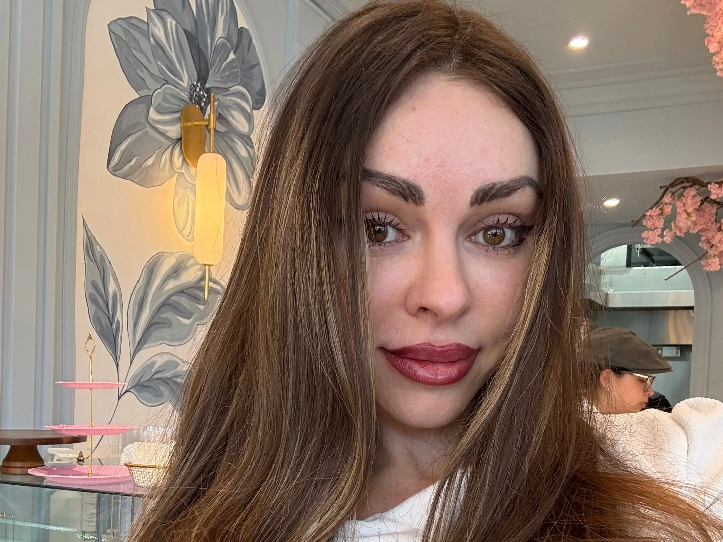 A smiling woman with long brown hair.